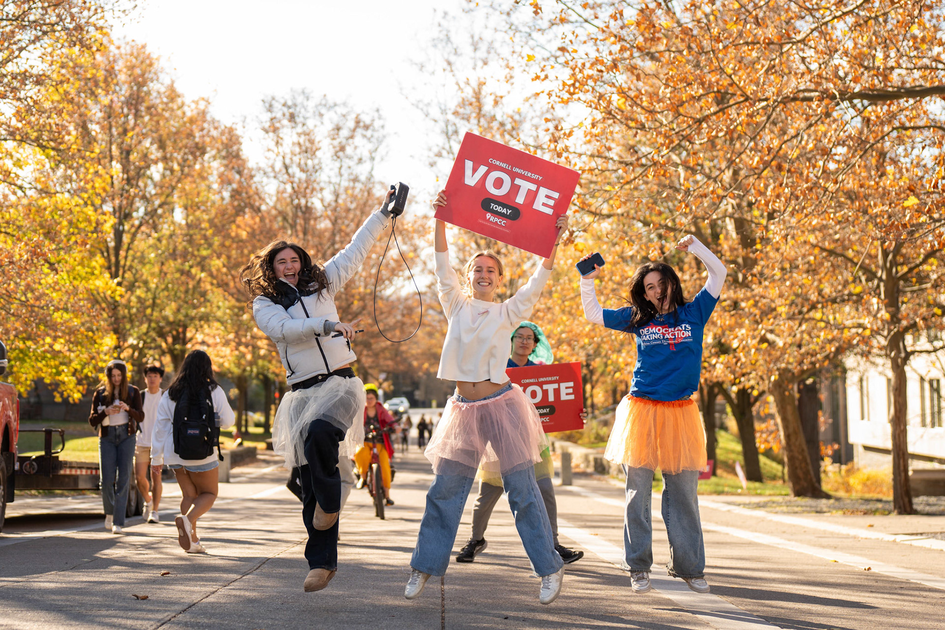 Kaitlin Ganshaw '25, Lena Cengotitabengoa '25, and Jacobi Kandel '25 remind students walking to class to vote on today's election day, Ho Plaza, Nov 5, 2024. (Ming DeMers/Sun Photography Editor)