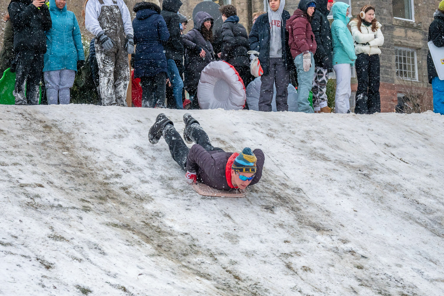 A student sleds down Libe Slope on March 14th, 2023. (Ming DeMers/Sun Asst Photo)