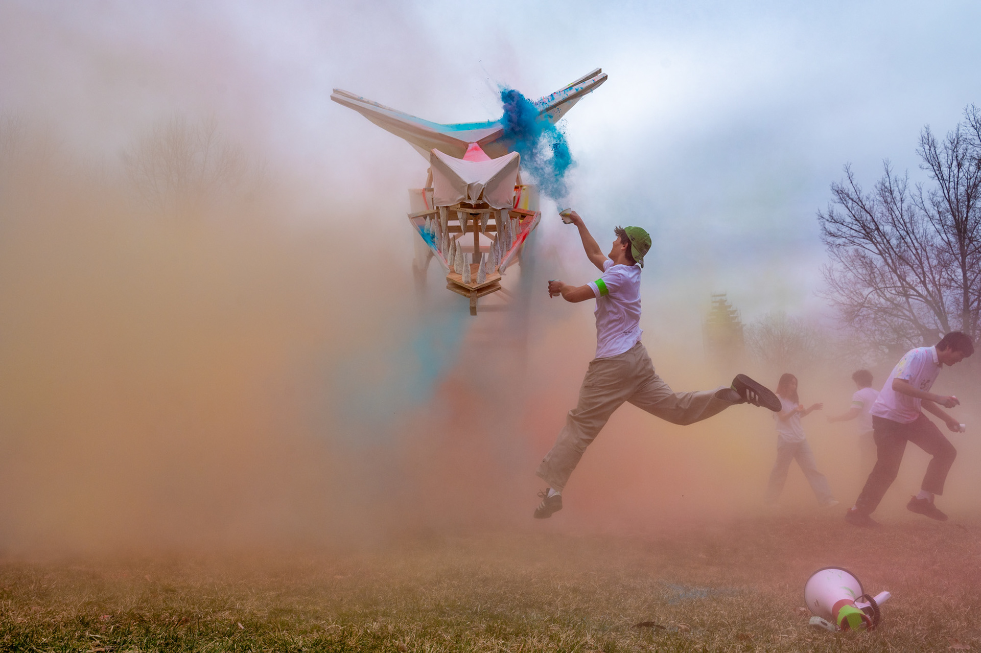 Students throw colored powder onto the dragon, Dragon Day Parade, Arts Quad, Mar 28, 2025. (Ming DeMers/Sun Senior Photographer)