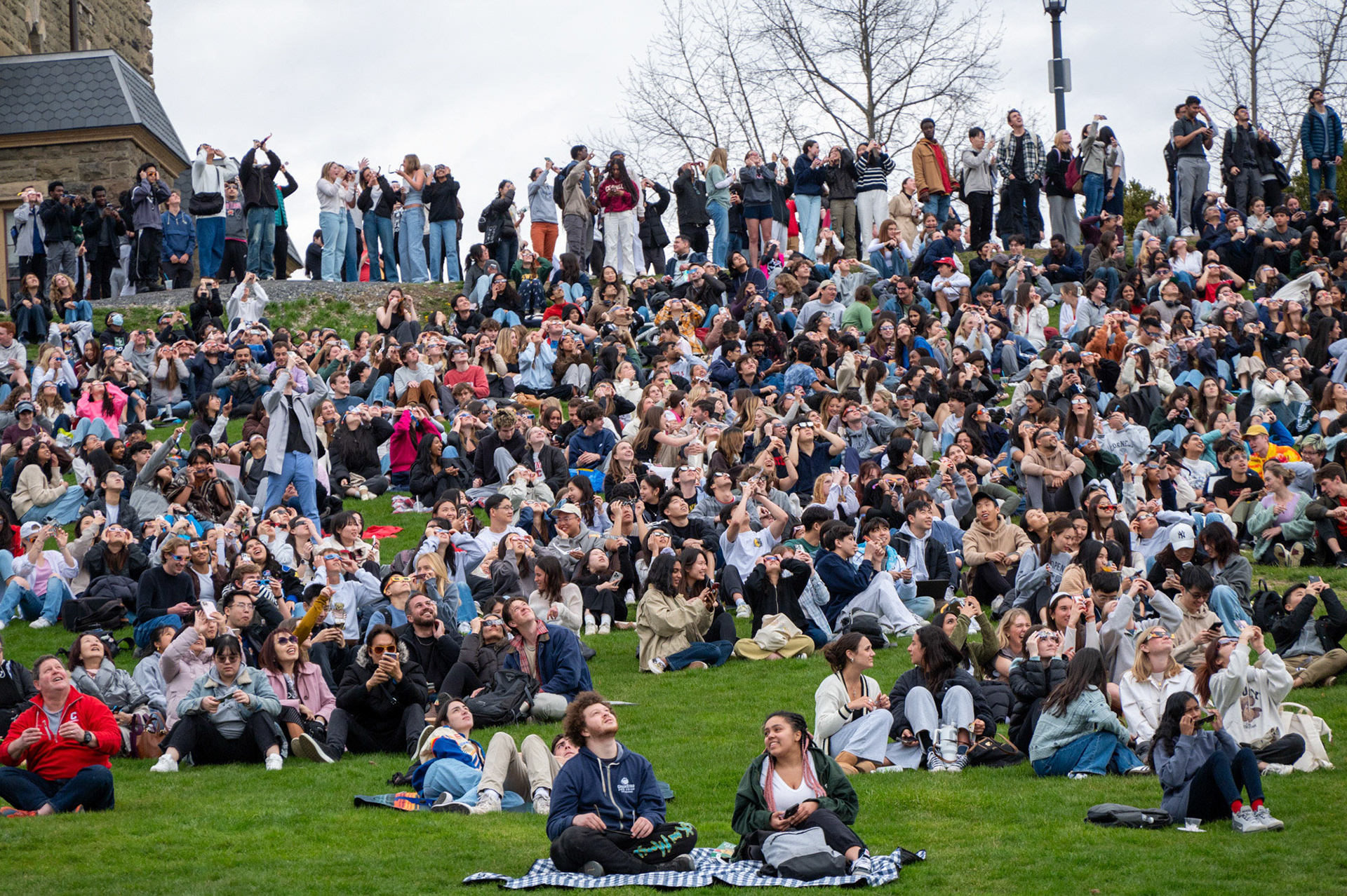 Hundreds of students gathered to view the solar eclipse on Libe Slope, April 8th, 2024. (Ming DeMers/Sun Senior Photo)