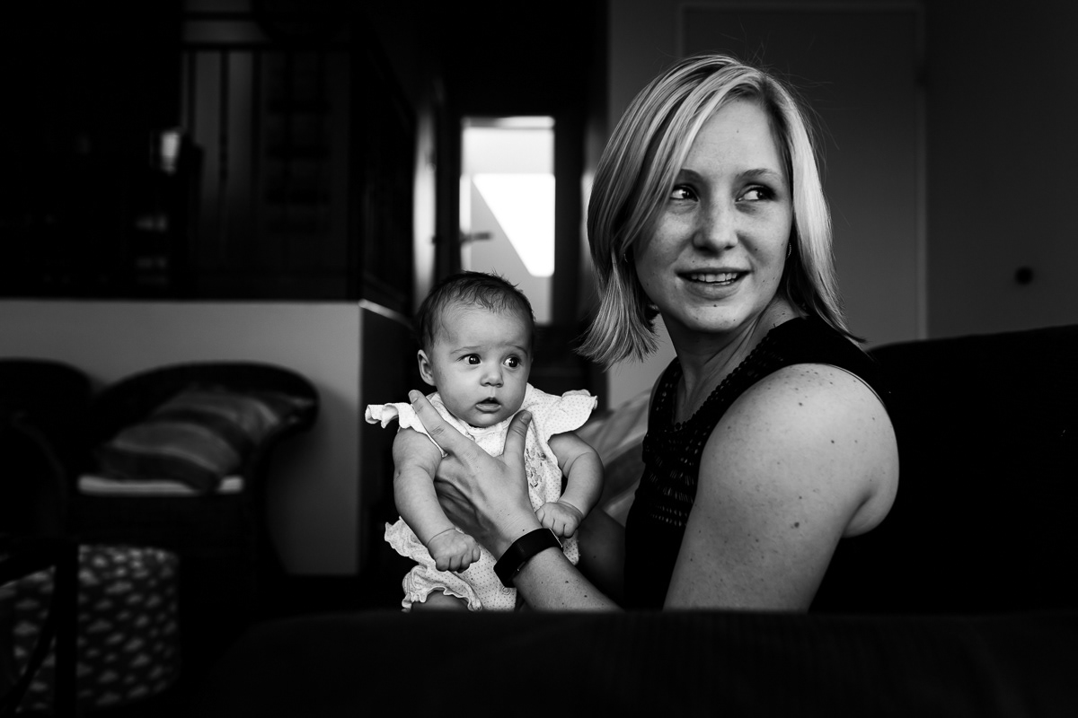 Mother and baby girl both looking at something