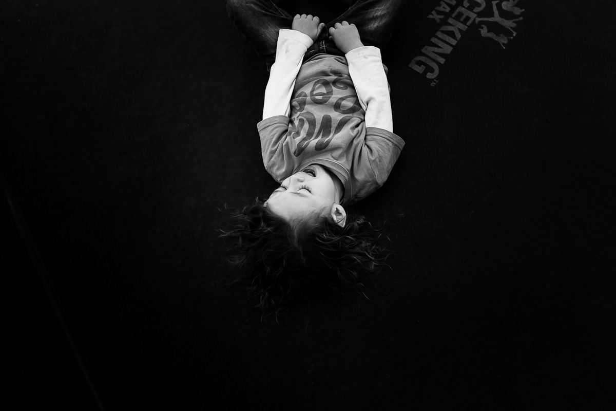 Boy lying on his back crying