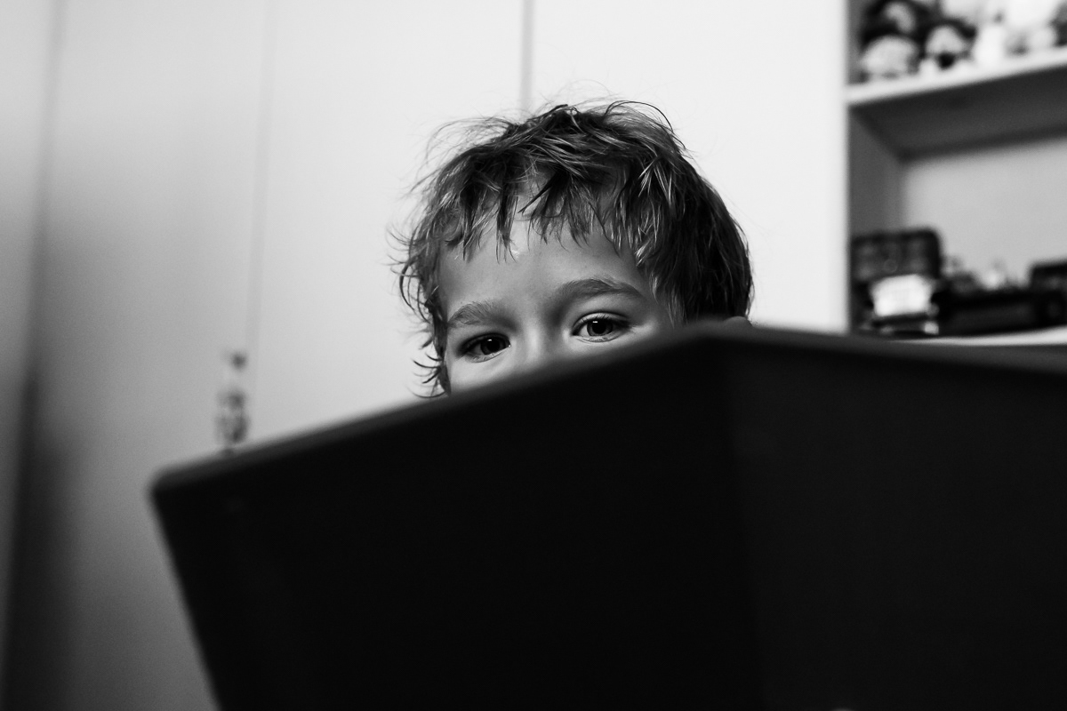 Boy peaking out over a box