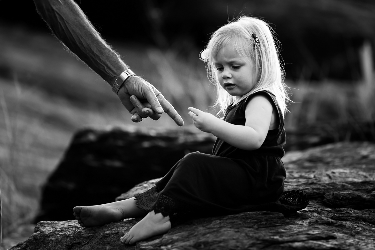 Someone's hand showing little girl something