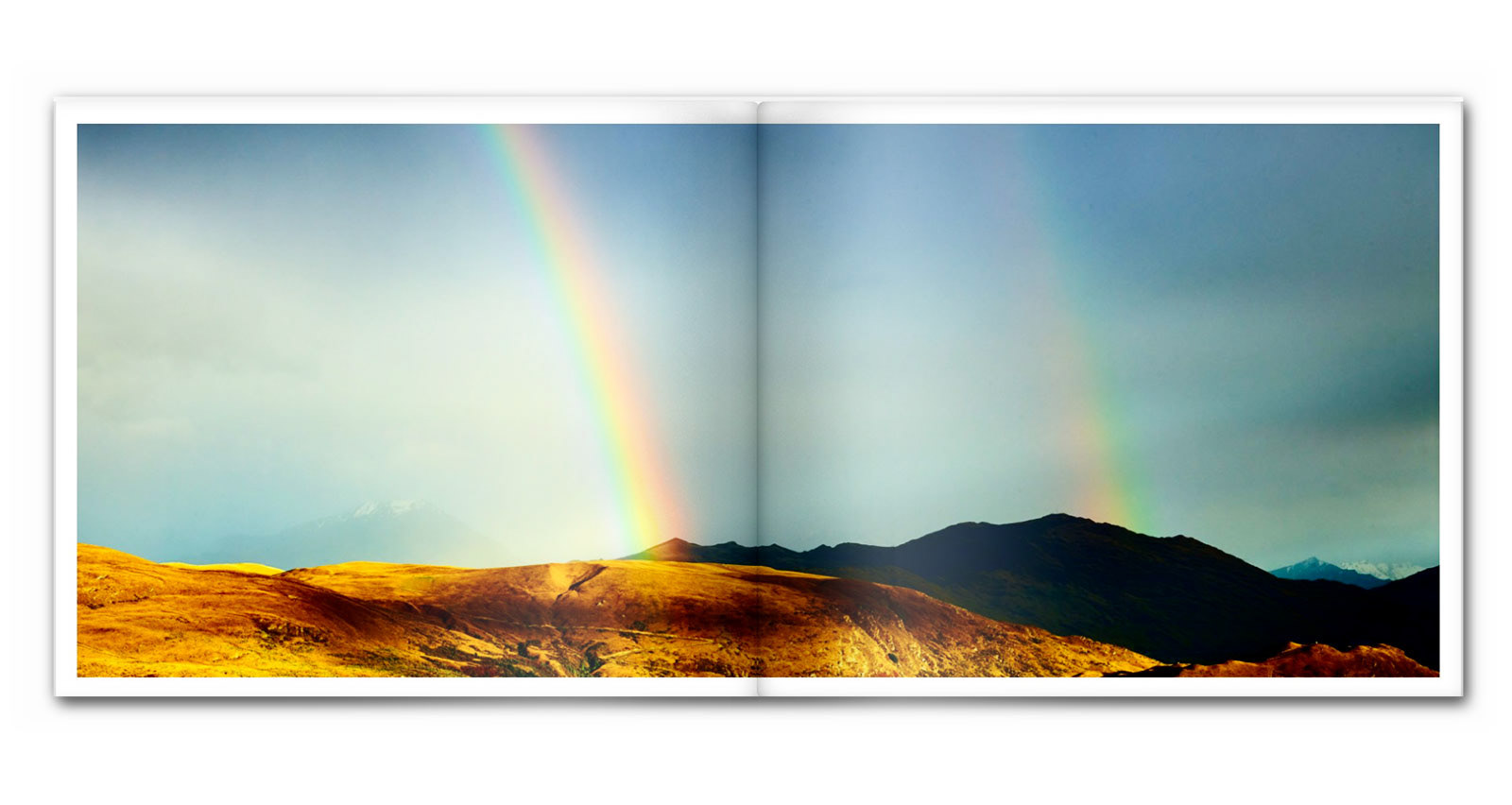 Panoramic image of a New Zealand Landscape with a rainbow.
