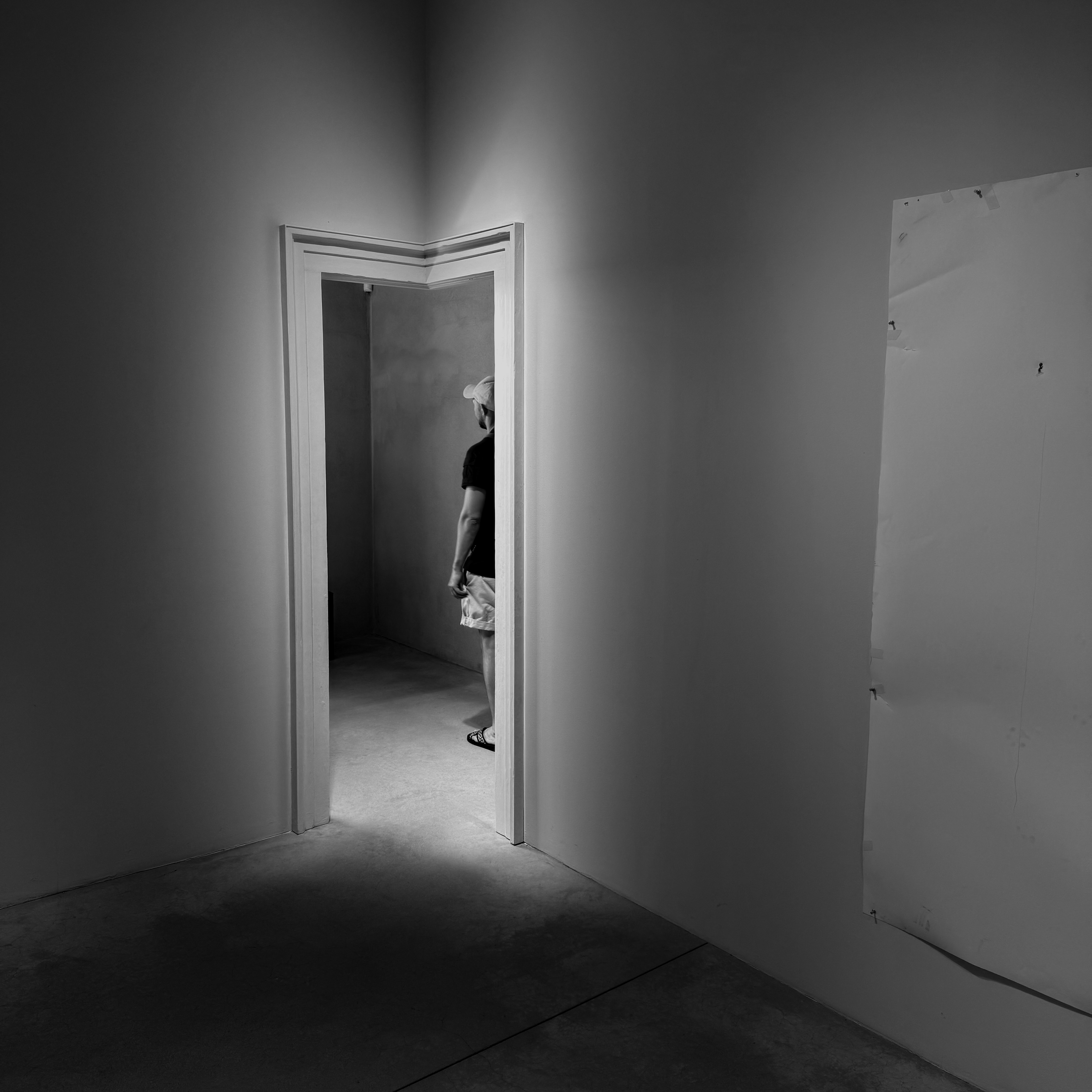 Open Corner 开放的角落 - Captured on the afternoon of 13 August 2025 at Fondazione Prada in Milan, this piece is set in a quiet nook of Robert Gober’s exhibition. The doorway, an artwork itself, was the sole entry point. Afternoon light streamed from a window into the corridor, making the threshold glow like a framed stage. Intrigued, I waited to observe each "protagonist". Over ten minutes, I captured three people; this is one. Drawn to the same window, his pause caught my eye. The wait remains vivid.