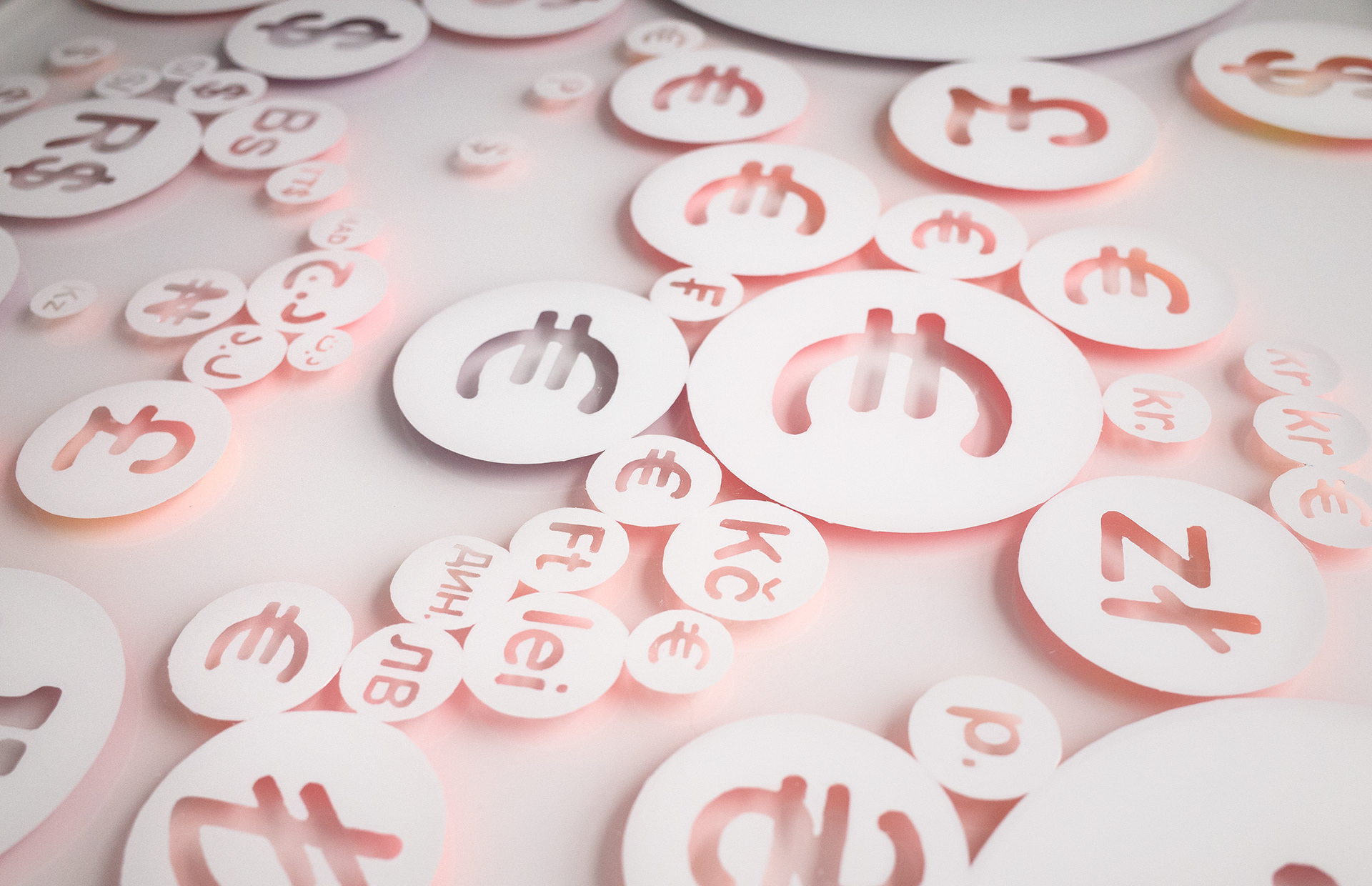 Painted white circles with currency symbols and an orange glow
