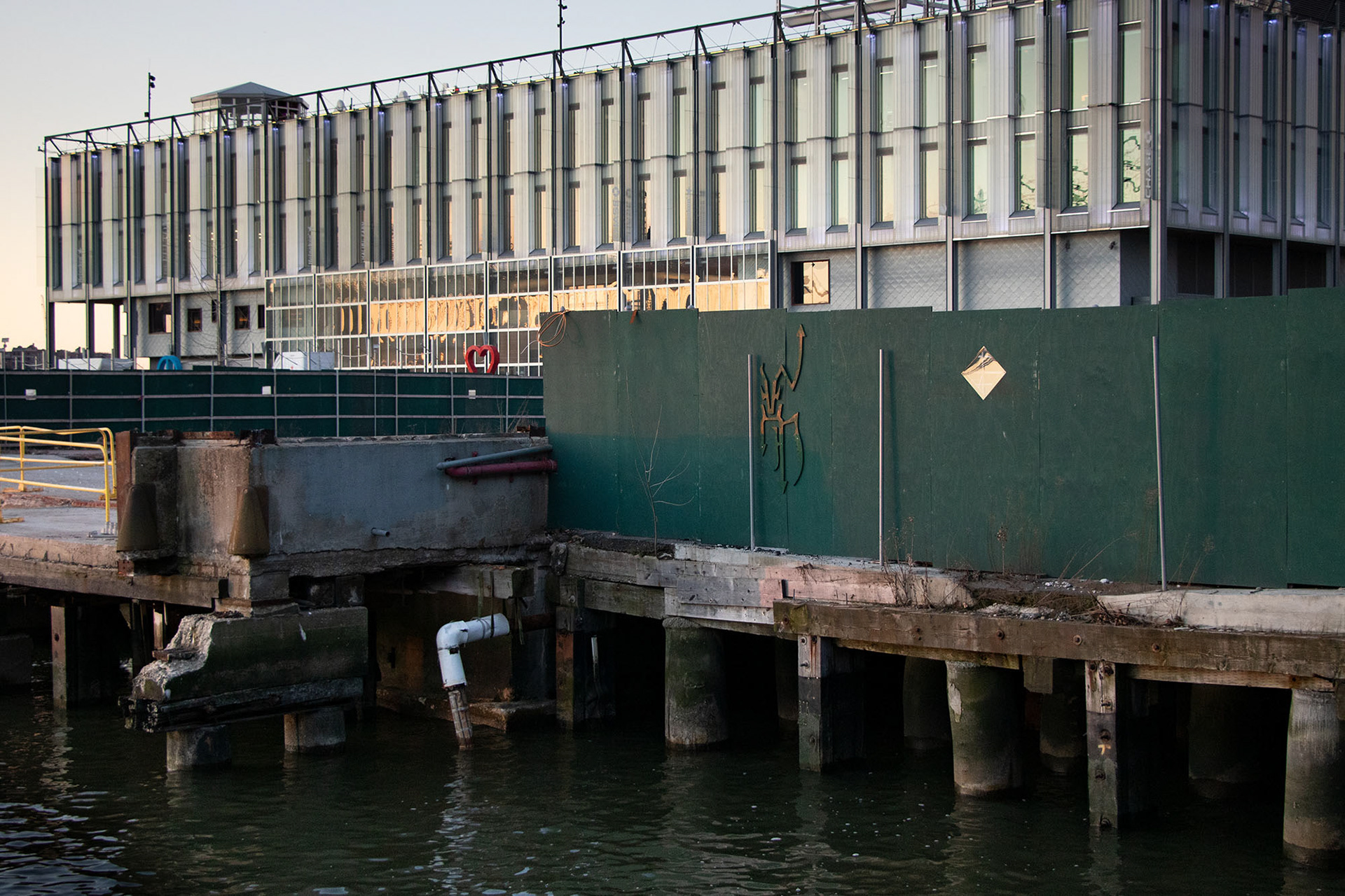 Shadow Puppet. 2022. Plywood, enamel, hardware on fence. 24” x 64” x 1”