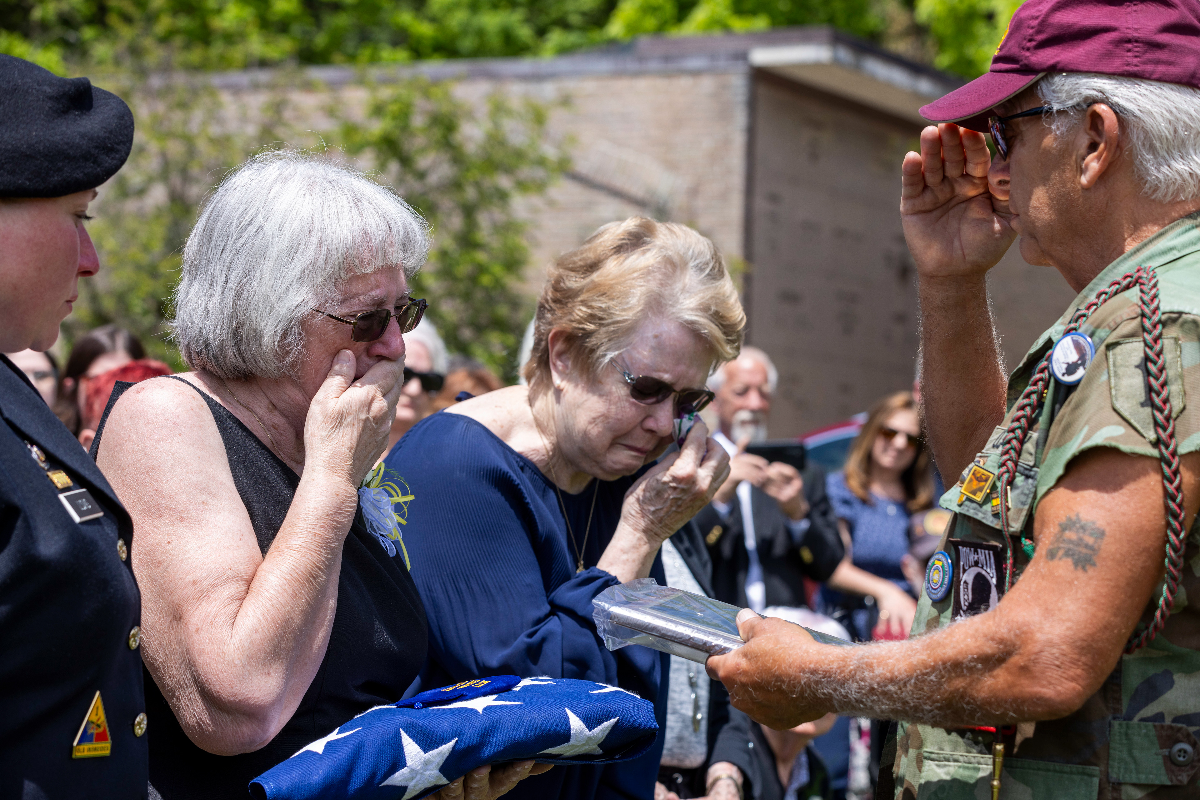 Ginnie Lee Henry accepts plaque during Pvt. Earl Seibert’s funeral service Saturday, May 25, 2024, at Grandview Cemetery in South Whitehall Township. Seibert died in July 1942 after he and his battalion were captured during World War II. His remains were recently discovered in a prisoner of war camp where he had been held.