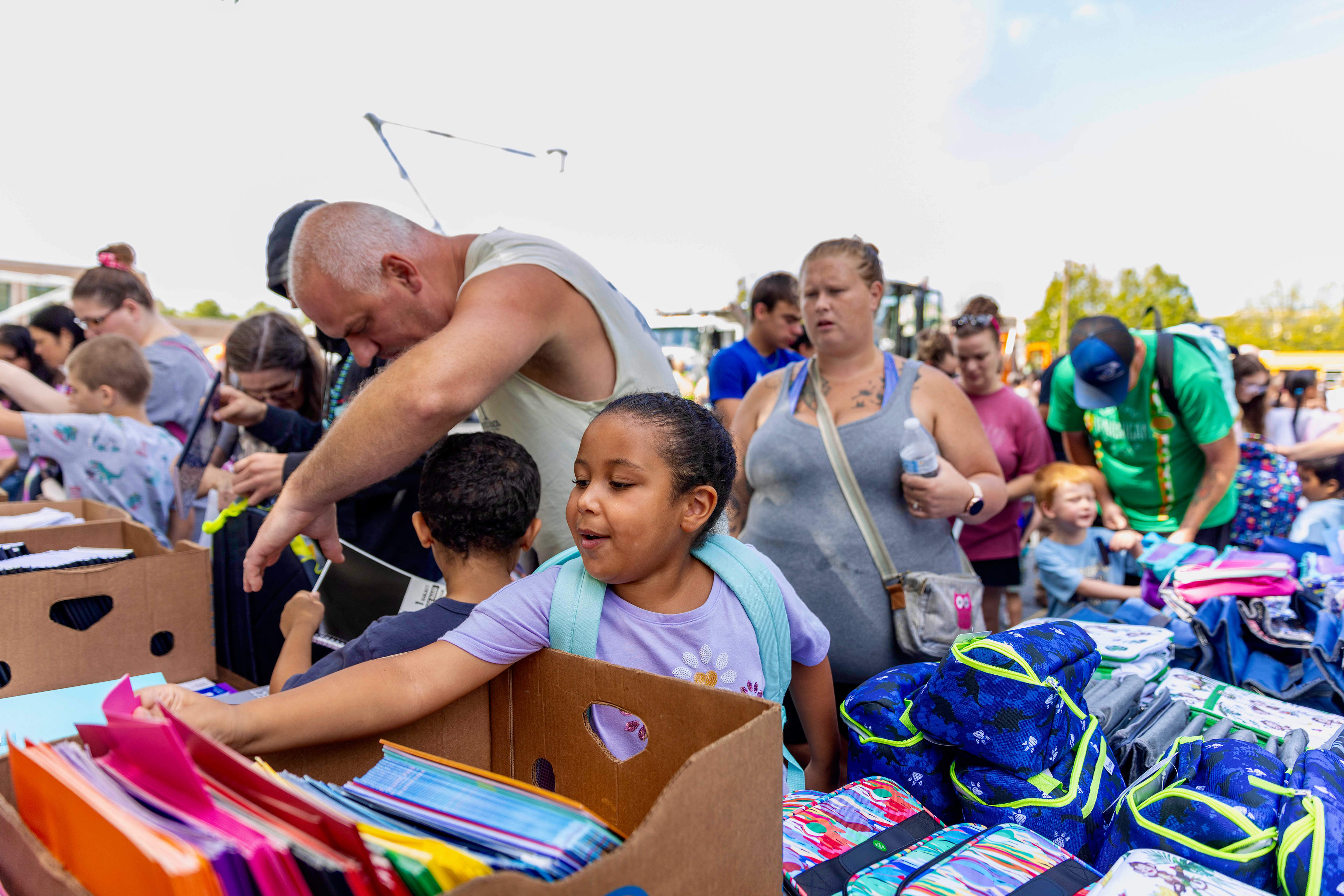 Dalilah Nakata, 7, of Bethlehem, grabs school supplies Sunday, Aug. 11, 2024, during the second annual Touch-A-Truck event at Wilson Area High School in Wilson. The event is hosted by Wilson Area Communities That Care Coalition to reduce economic stress, assist students with school supplies and provide fun for families in the Wilson Area community.