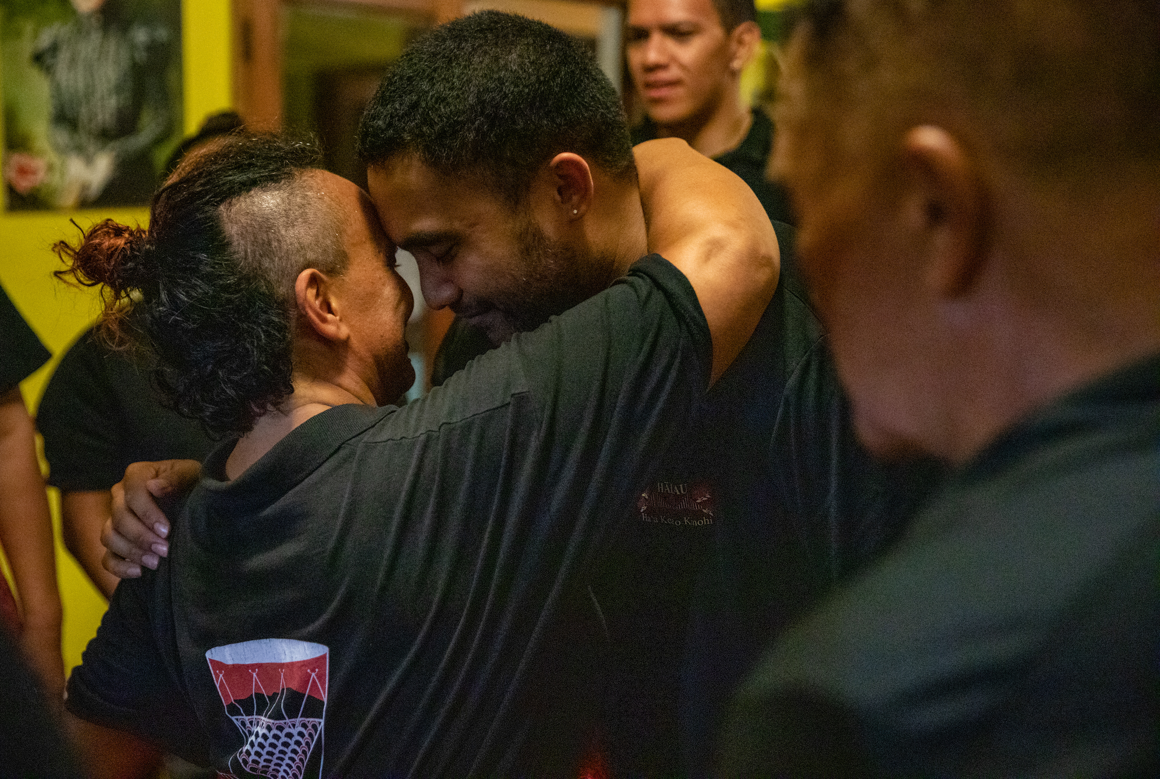 Claire "Tiare" Mataoa, 46, embraces Kinohi Neves, 31, in a honi after receiving the pa'u (hula skirt) blessing from the Kumu at his home on August 2, 2022. A honi is an ancient greeting that honors the heart and soul of the other human being.