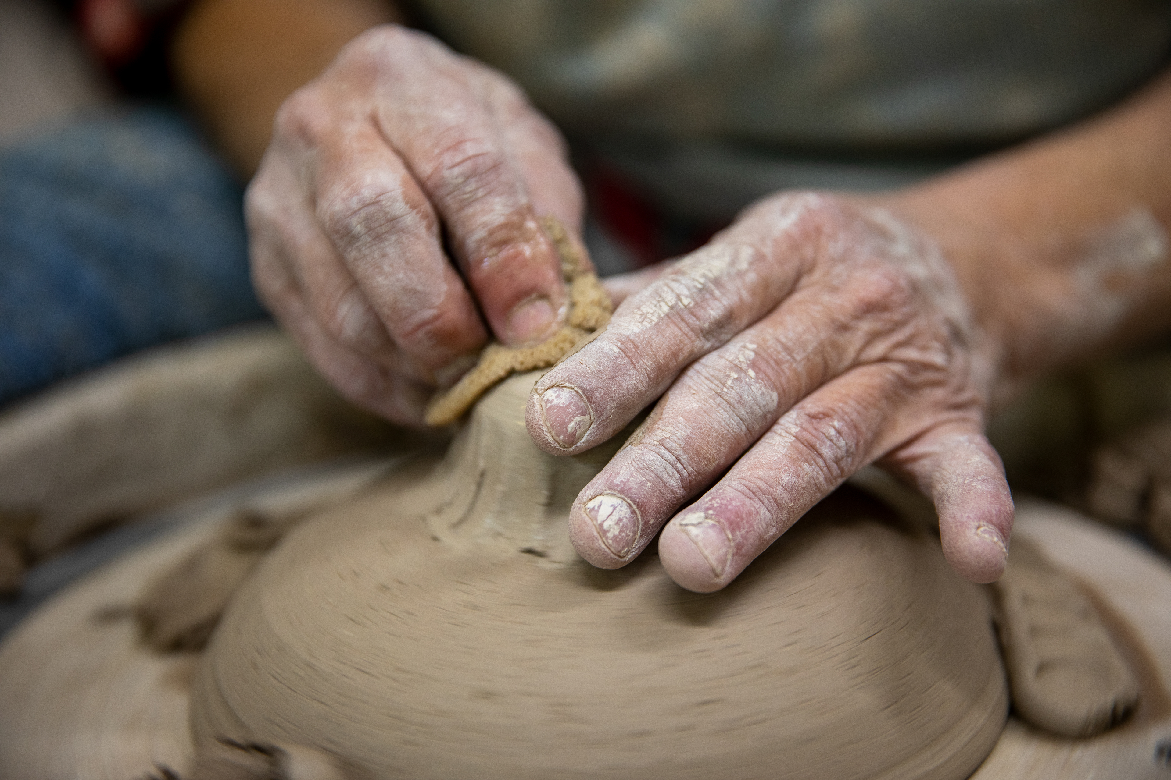 Hands of Susan Abramovitz, 71, as she throws a vegetable steamer at her studio at Rock Riffle Run Pottery on October 4, 2022.