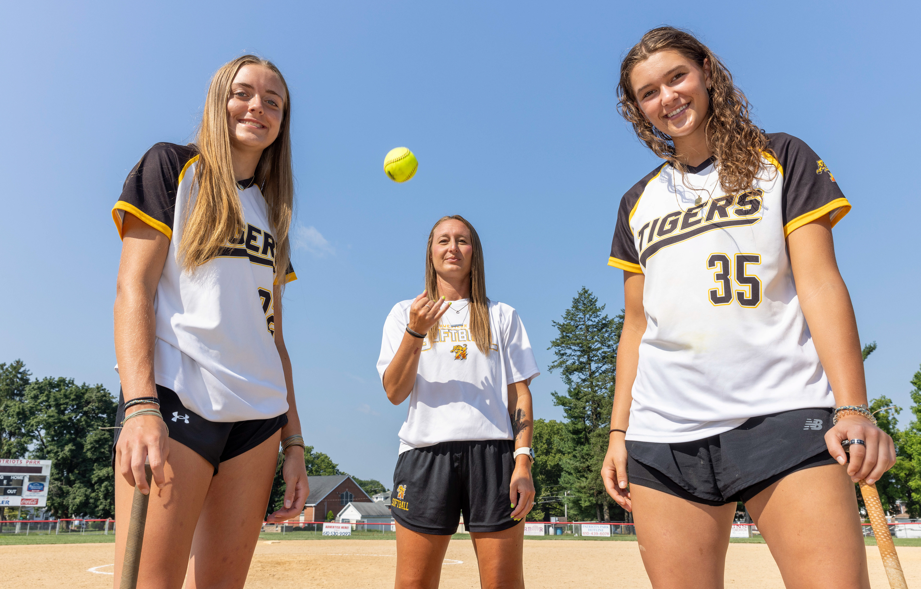 Northwestern Lehigh High School’s Emma Freeman, left, Northwestern Lehigh softball coach Kate Farber, and Northwestern Lehigh High School’s Abby Dunstan pose for a portrait Monday, July 15, 2024, in Allentown. Northwestern Lehigh is The Morning Call’s softball team of the year.