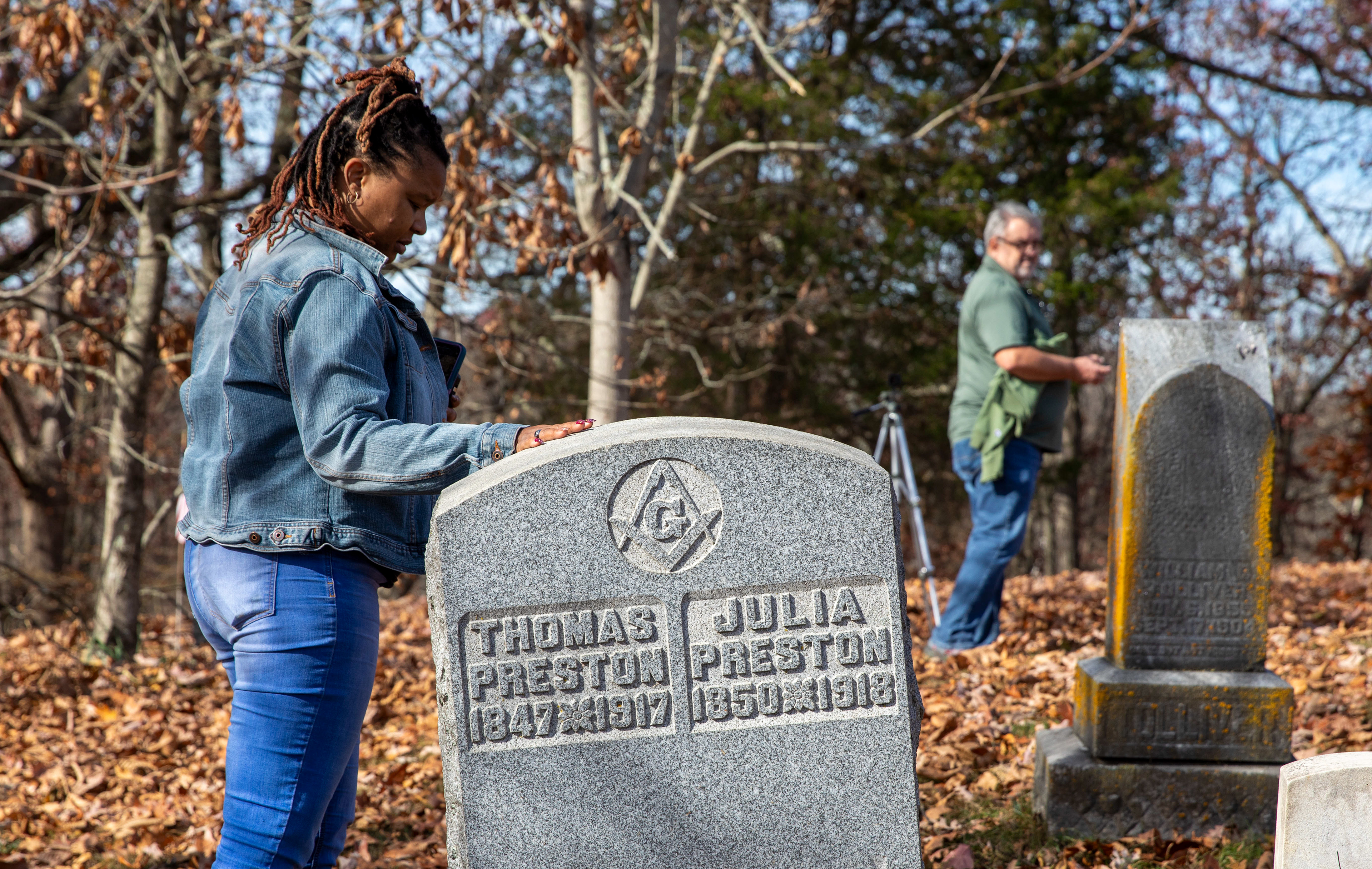 Courtney Preston Howard touches a gravestone of one of her ancestors during the Headstone Rededication Ceremony at Rendville Cemetery.