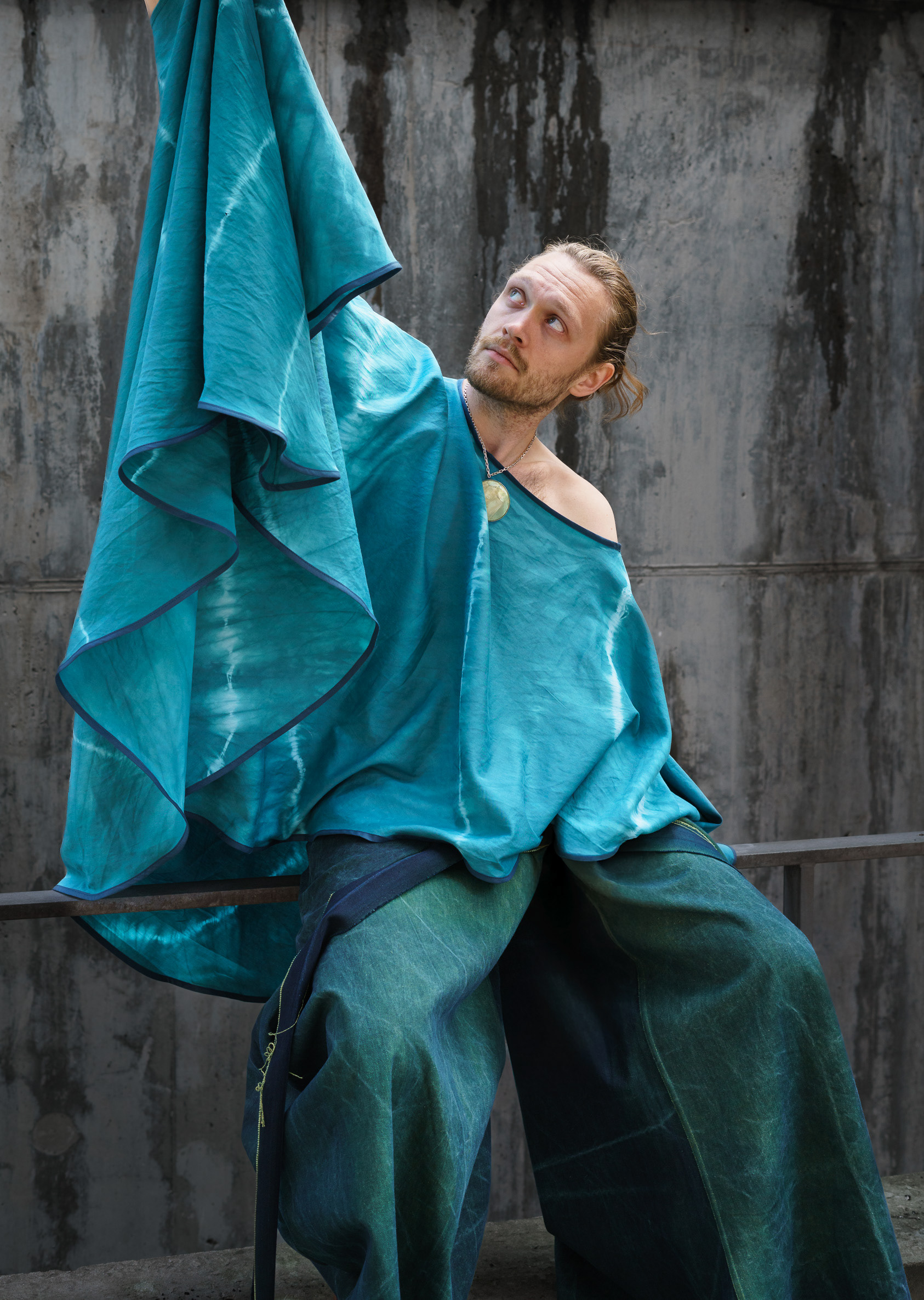 Asymmetrical cape in hand-dyed cotton satin, featuring a single side opening for the hand.