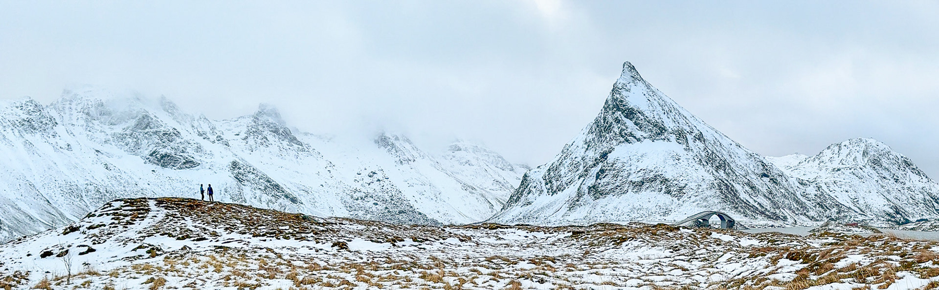 2 of our group looking at the highway bridge and mountains (iphone pano)