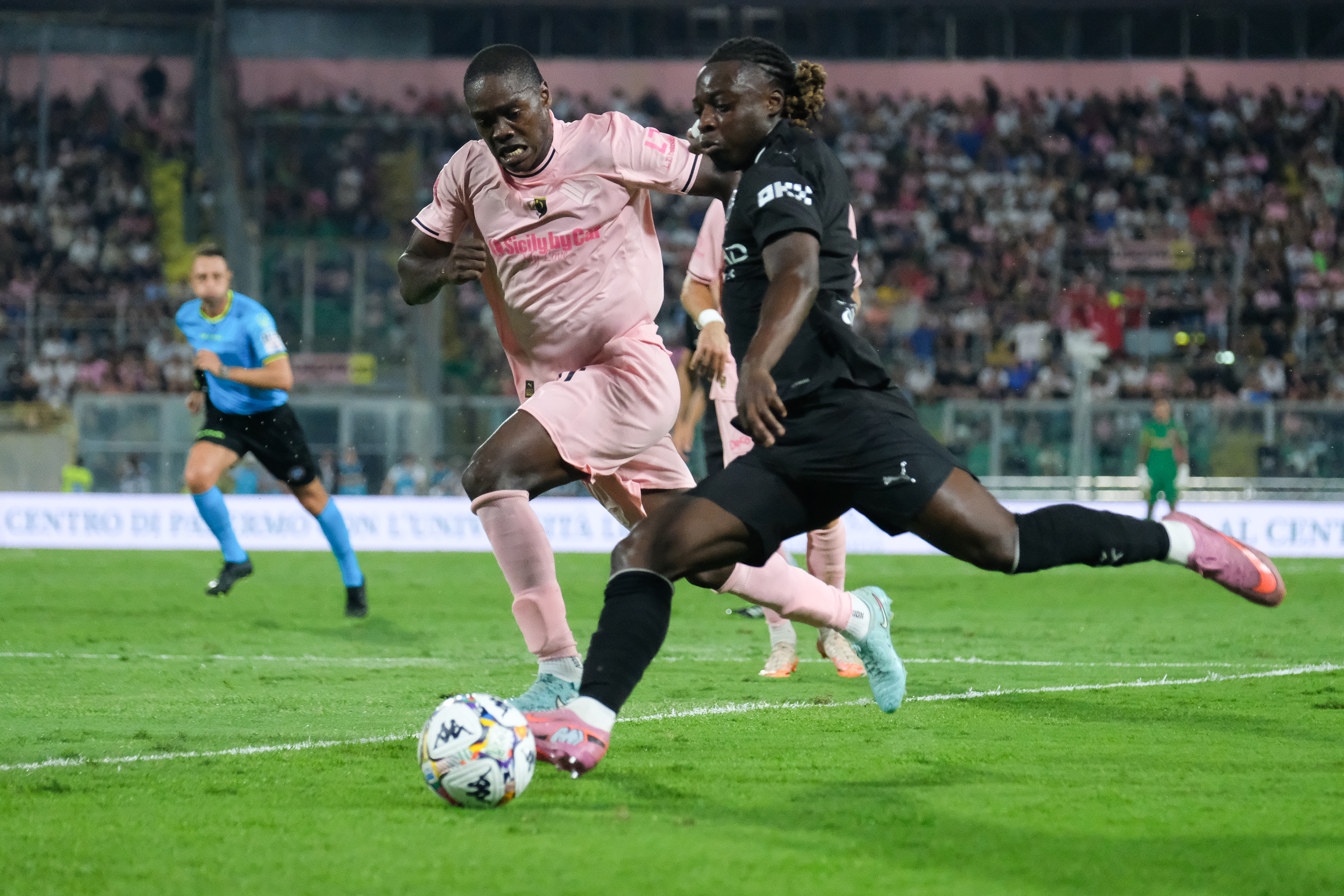 PALERMO FC v MANCHESTER CITY - Anglo Palermitan Trophy // PALERMO, ITALY - AUGUST 09: Emanuel Jyasi of Palermo FC (L) and Jeremy Doku in action during the friendly match between Palermo FC and Manchester City at Stadio Comunale Renzo Barbera on august 09, 2025 in Palermo, Italy. (Photo by Federico Serra)