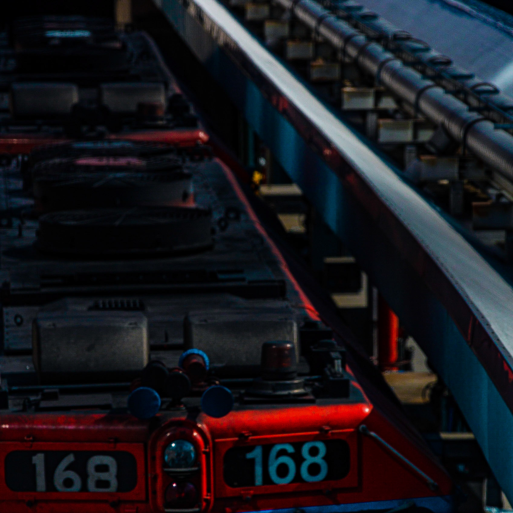 168 | A quick snap at 200mm from inside a moving train over the tops of an diesel-electric engine sitting at the ready in an adjoining train yard.