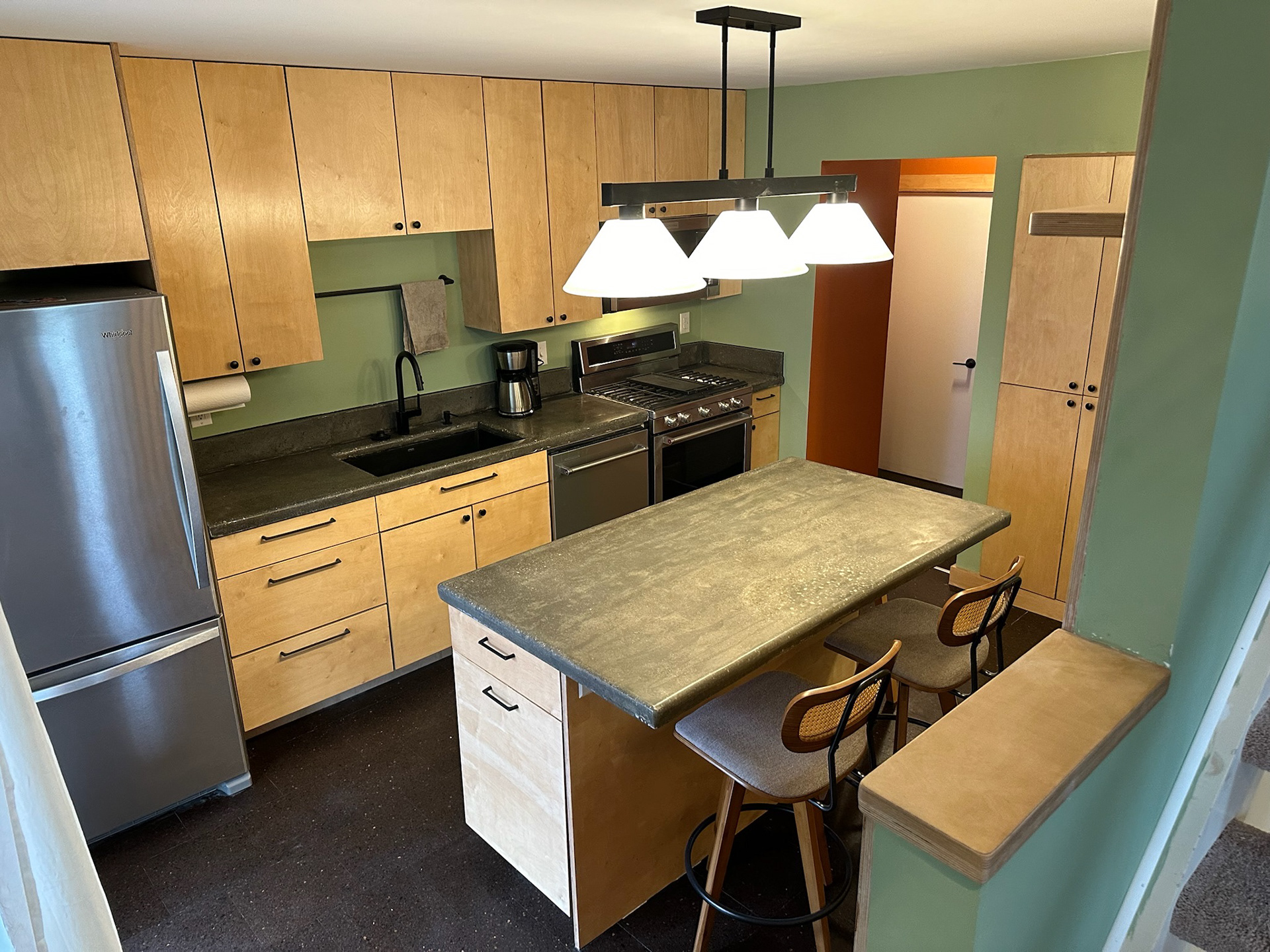 After, including custom wood slats, cabinetry and concrete countertops