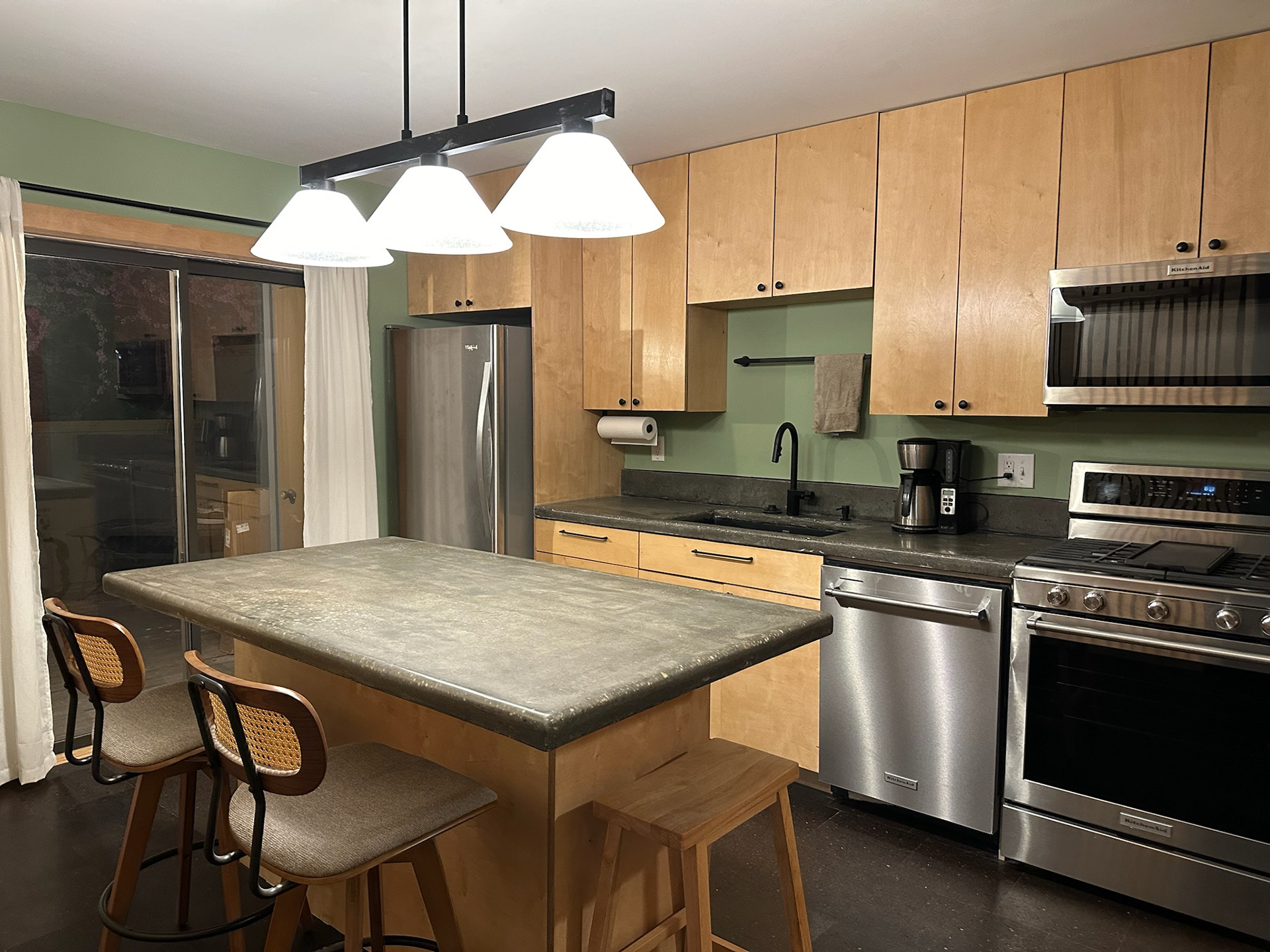 After, including custom wood slats, cabinetry and concrete countertops