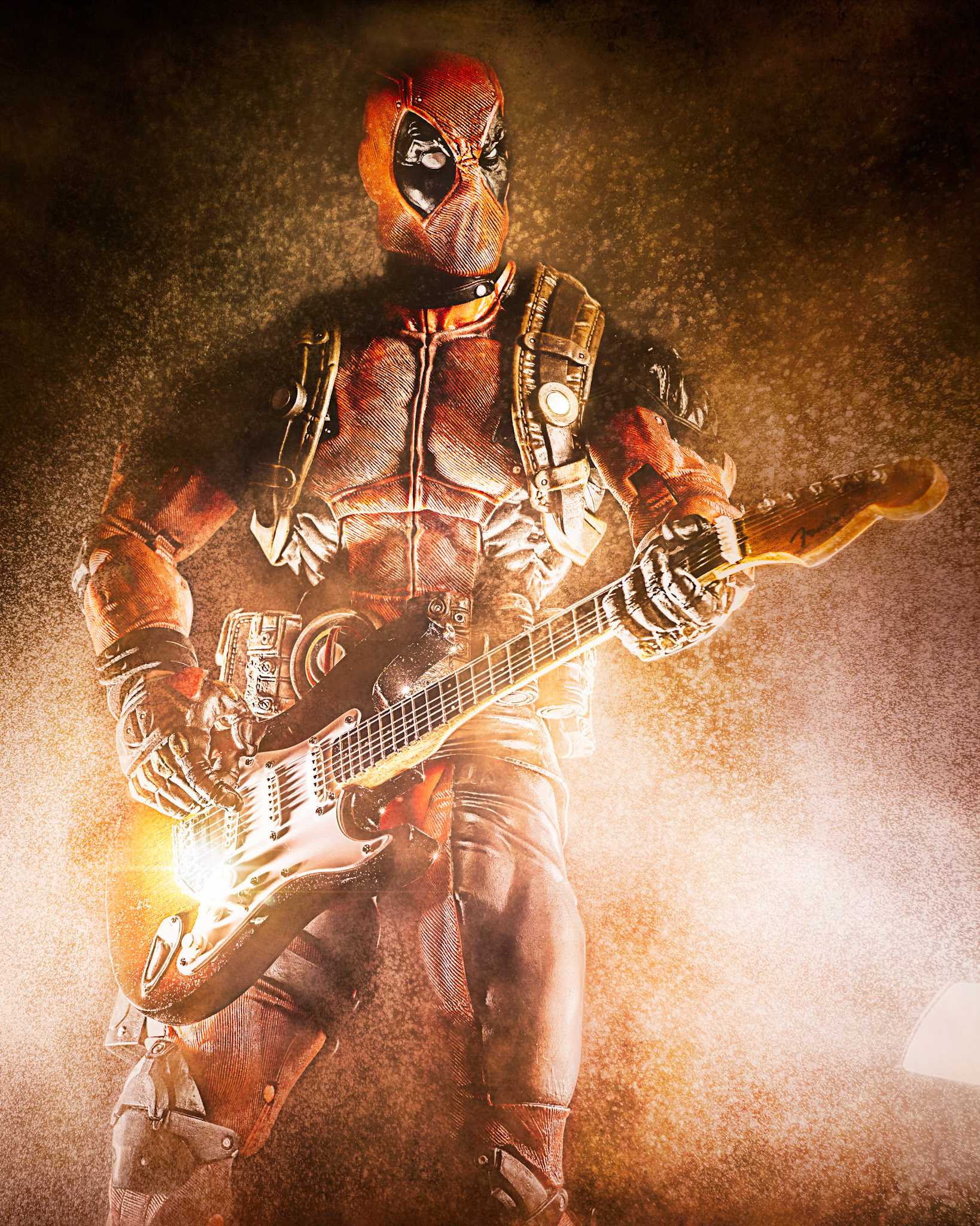 Deadpool rocks out with a Fender Stratocaster guitar.