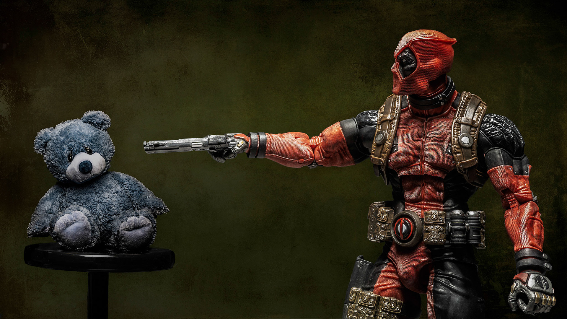 Deadpool threatens Cable’s teddy bear.