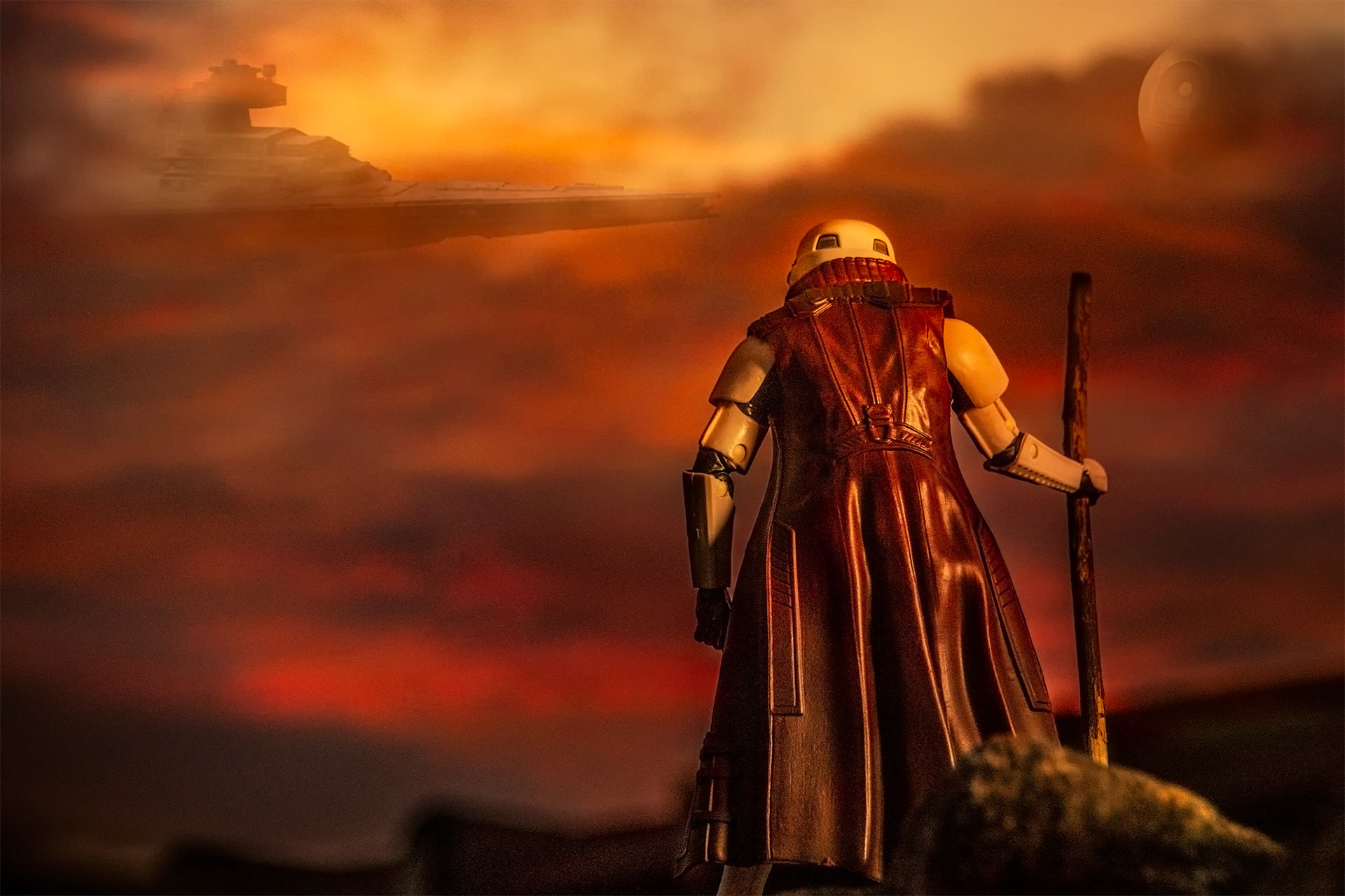 Hiking Stormtrooper overlooking the Death Star and a Star Destroyer hovering in a blood red sky.