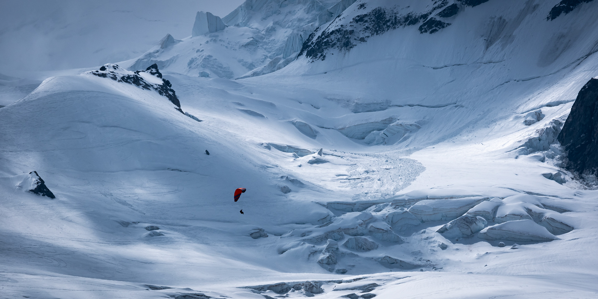 Light was dancing on the snowy slopes of Mont-Blanc. When this paraglider came in, I could almost hear the stilness around her, gazing around to the perfect show that nature offers us.