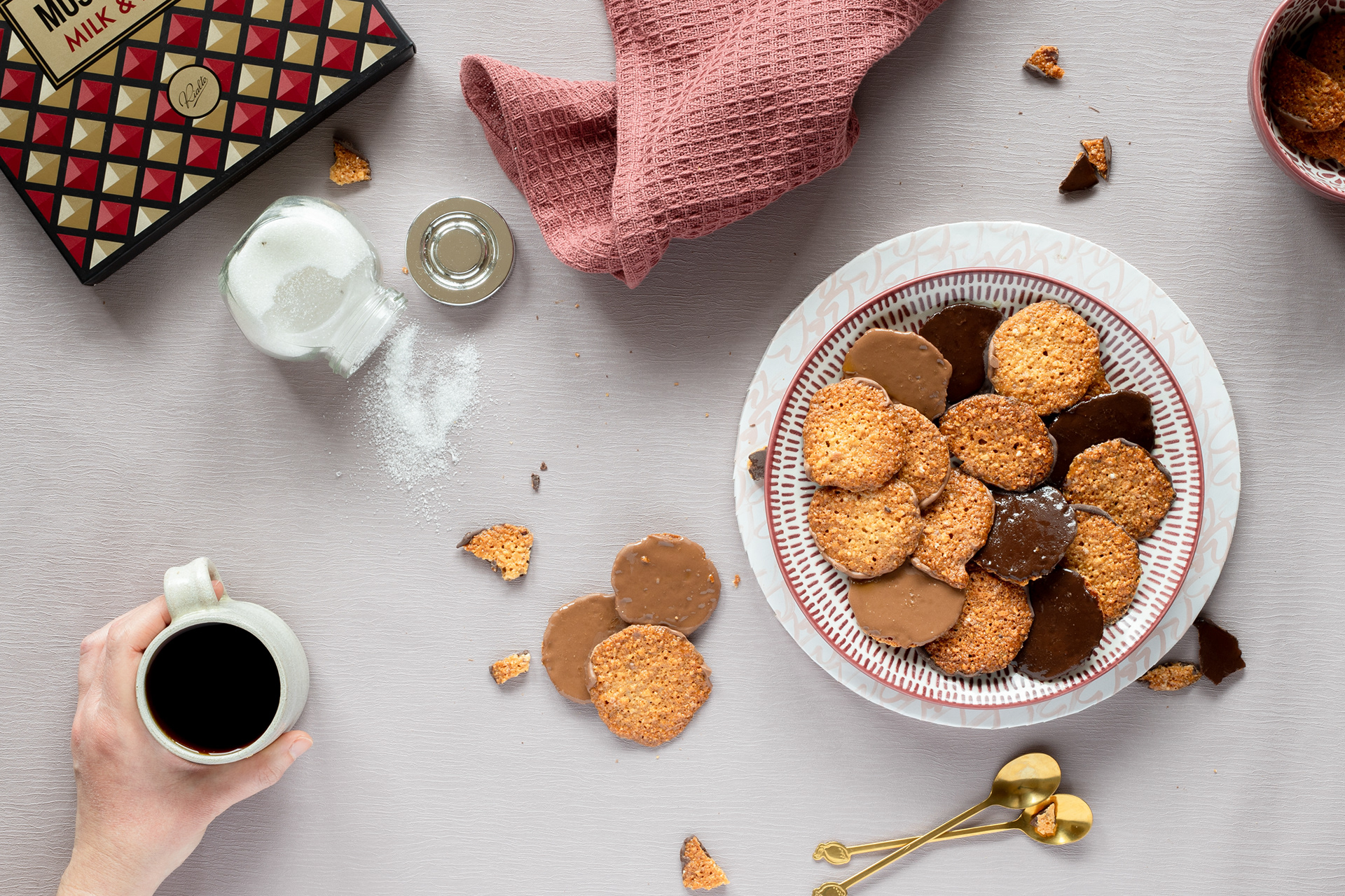Chocolate and almond cookies in a plate with a cup of coffee, food photography