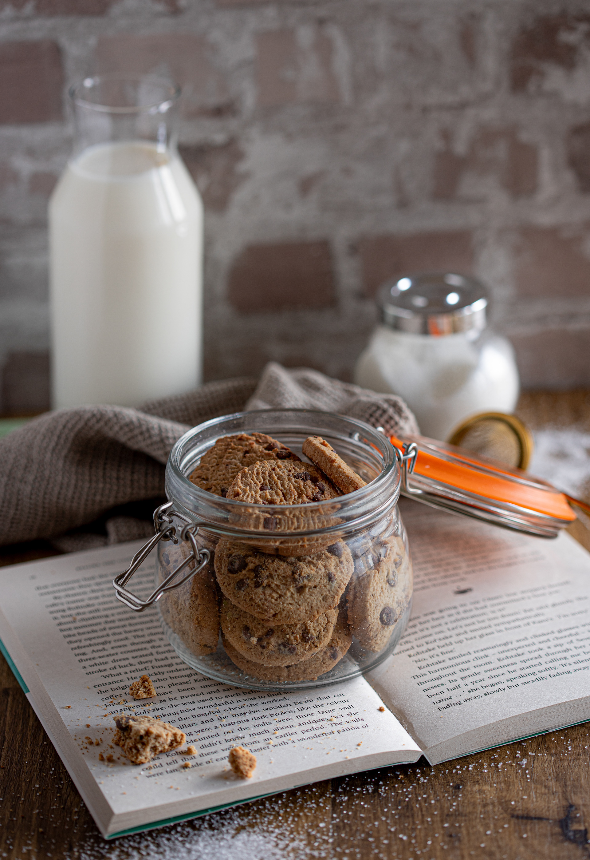 Chocolate chip cookies in a jar and bottle of milk