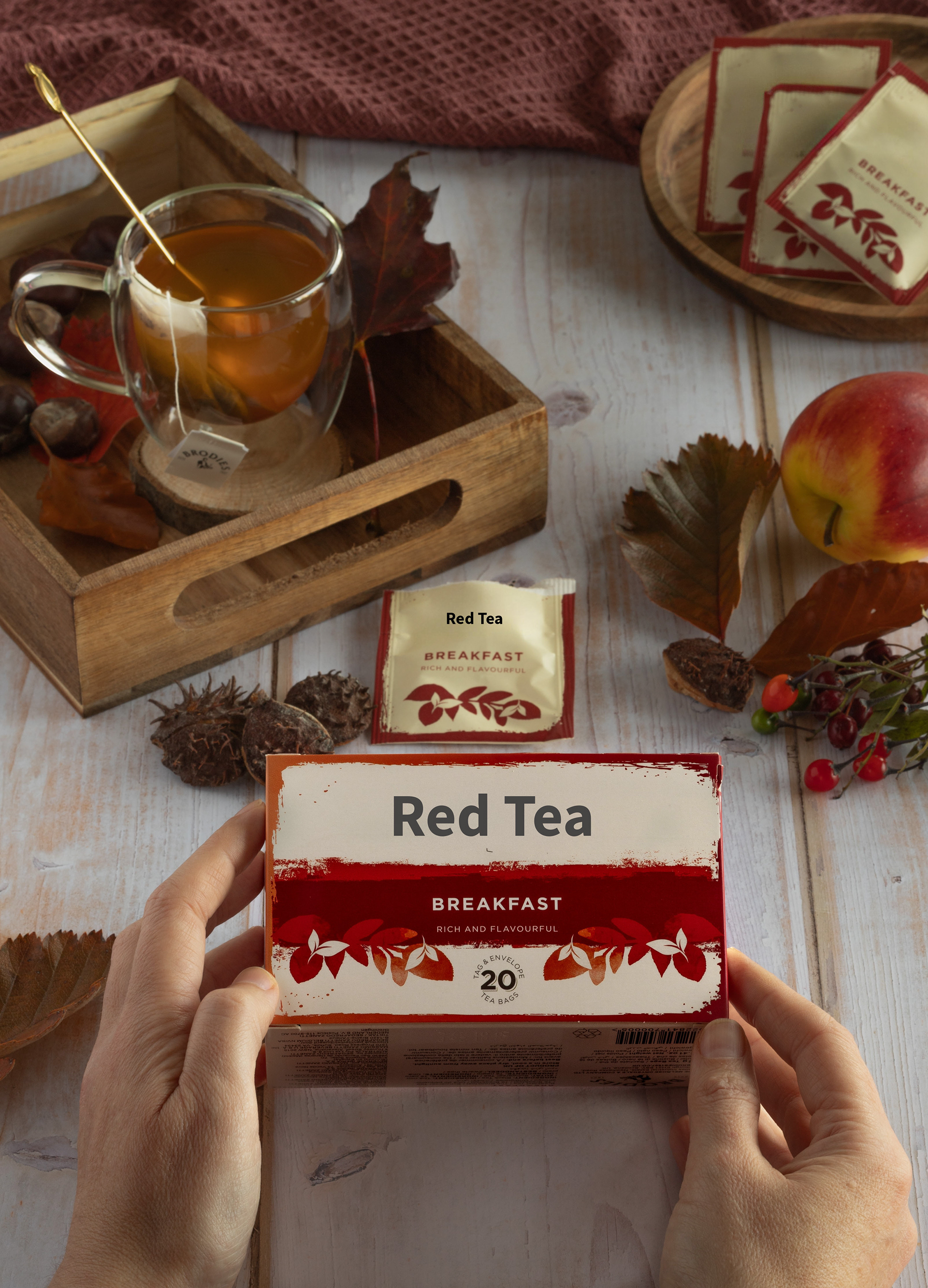 Hands holding red tea package