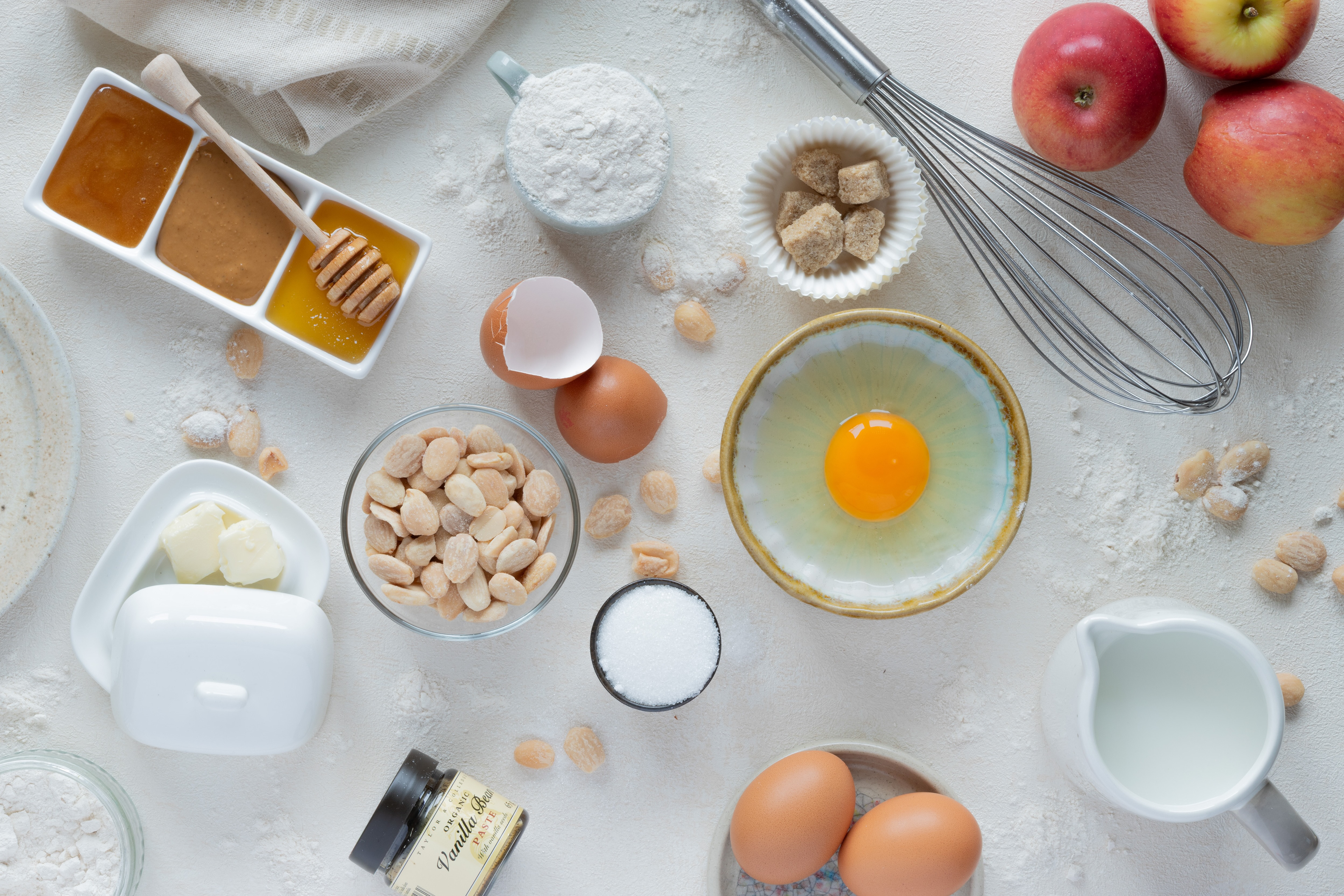 Preparation of dessert with almonds, butter, eggs, sugar, vanilla, apples, milk and flour, food photography