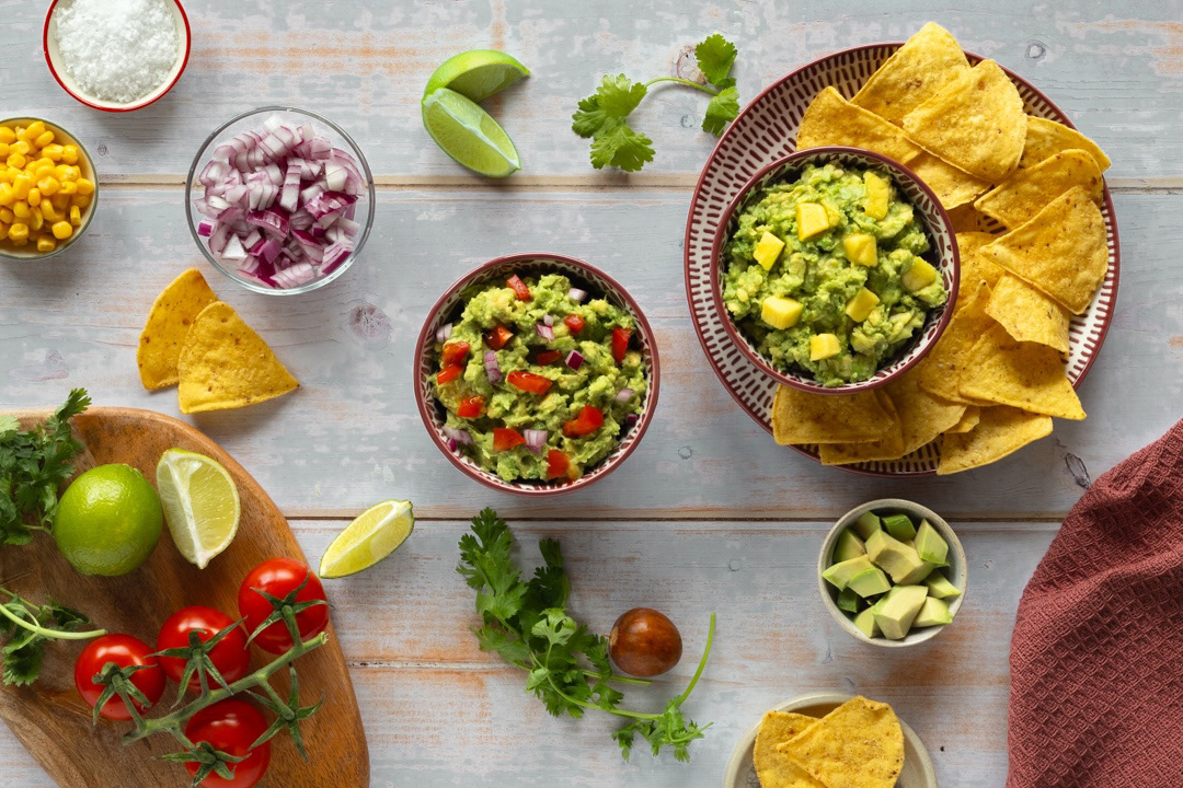 Preparation of nachos and guacamole with mango