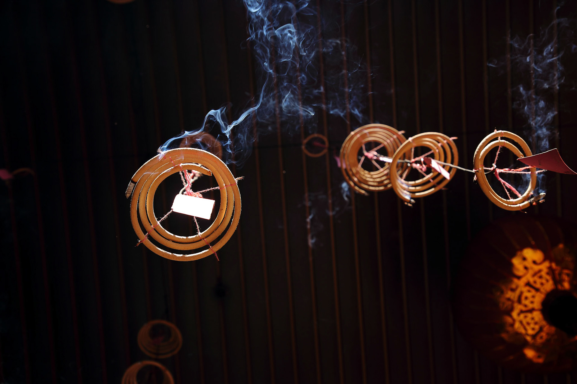 Smoking incense Spiral shaped Chinese prayer joss stick hanging from the ceiling