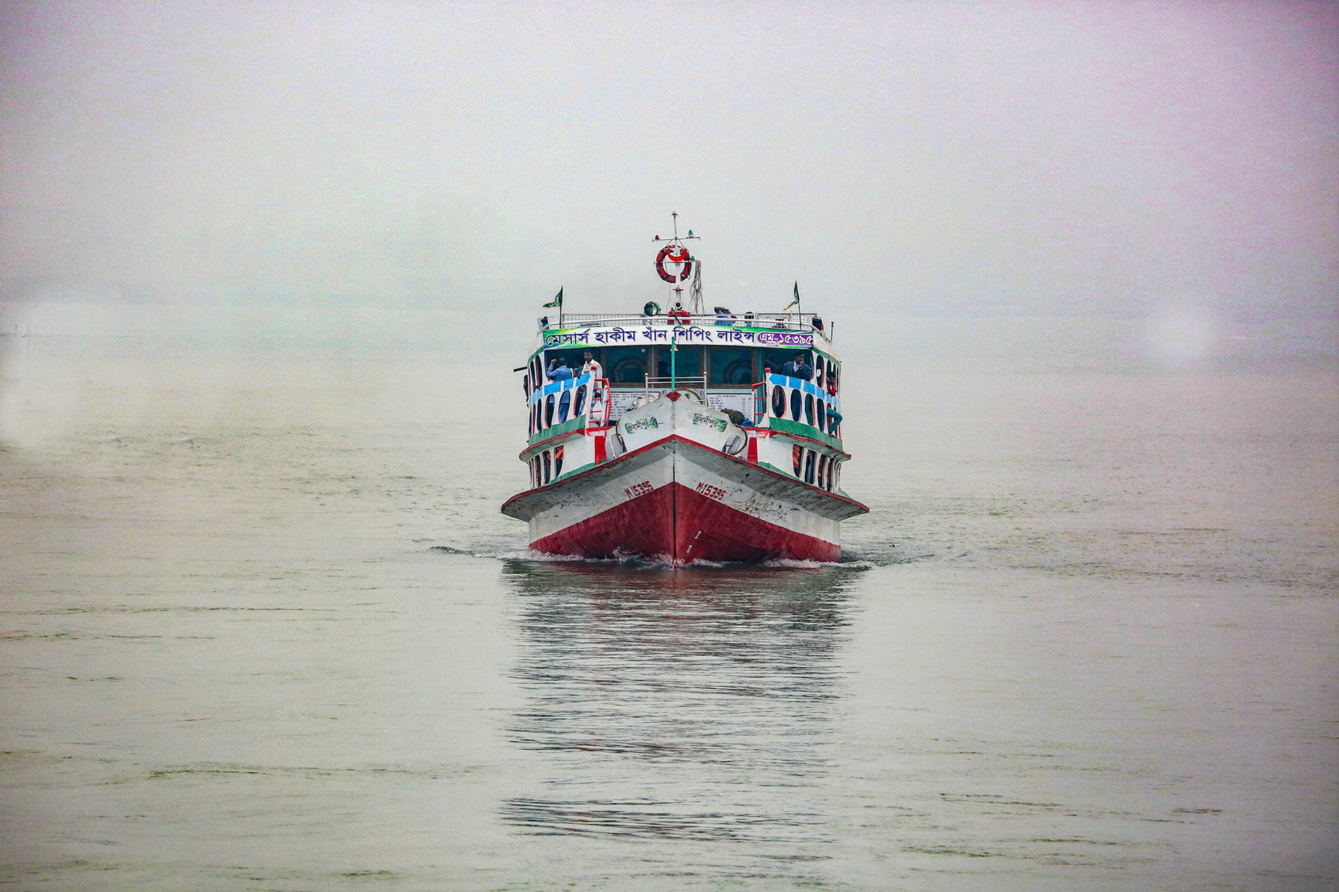 River Padma, Bangladesh - February 14, 2016: Passenger ferry boat going through fog on Padma river in Bangladesh
