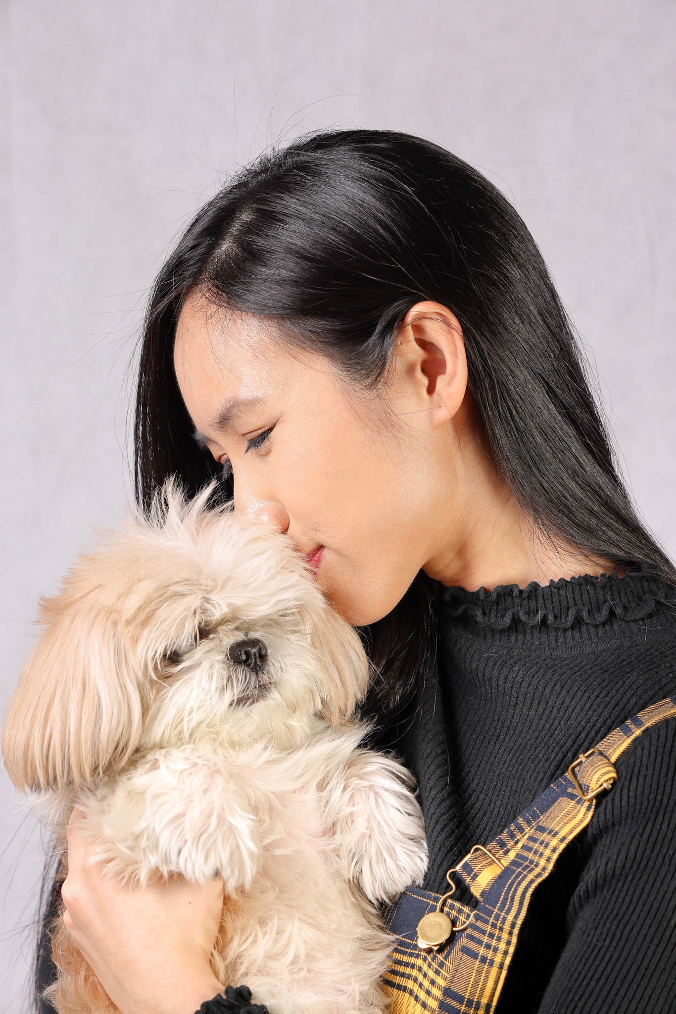Young attractive Asian woman holding carrying posing love affection cute little furry dog