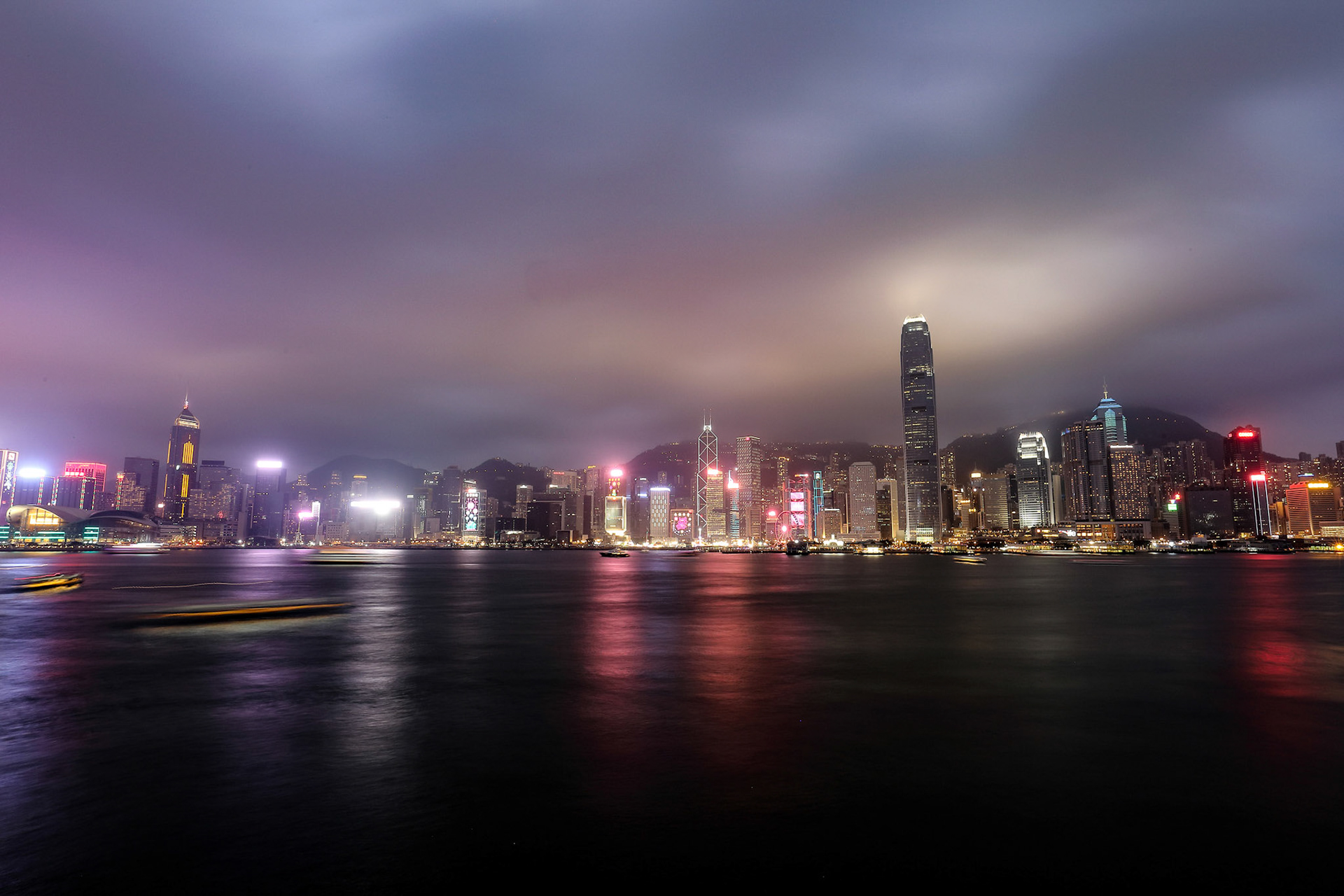 KOWLOON, HONG KONG-FEBRUARY 17, 2018 - View of Hong Kong form Kowloon harbour front. The whole city lights up in the evening and the choreographed symphony of laser is dazzling light show.
