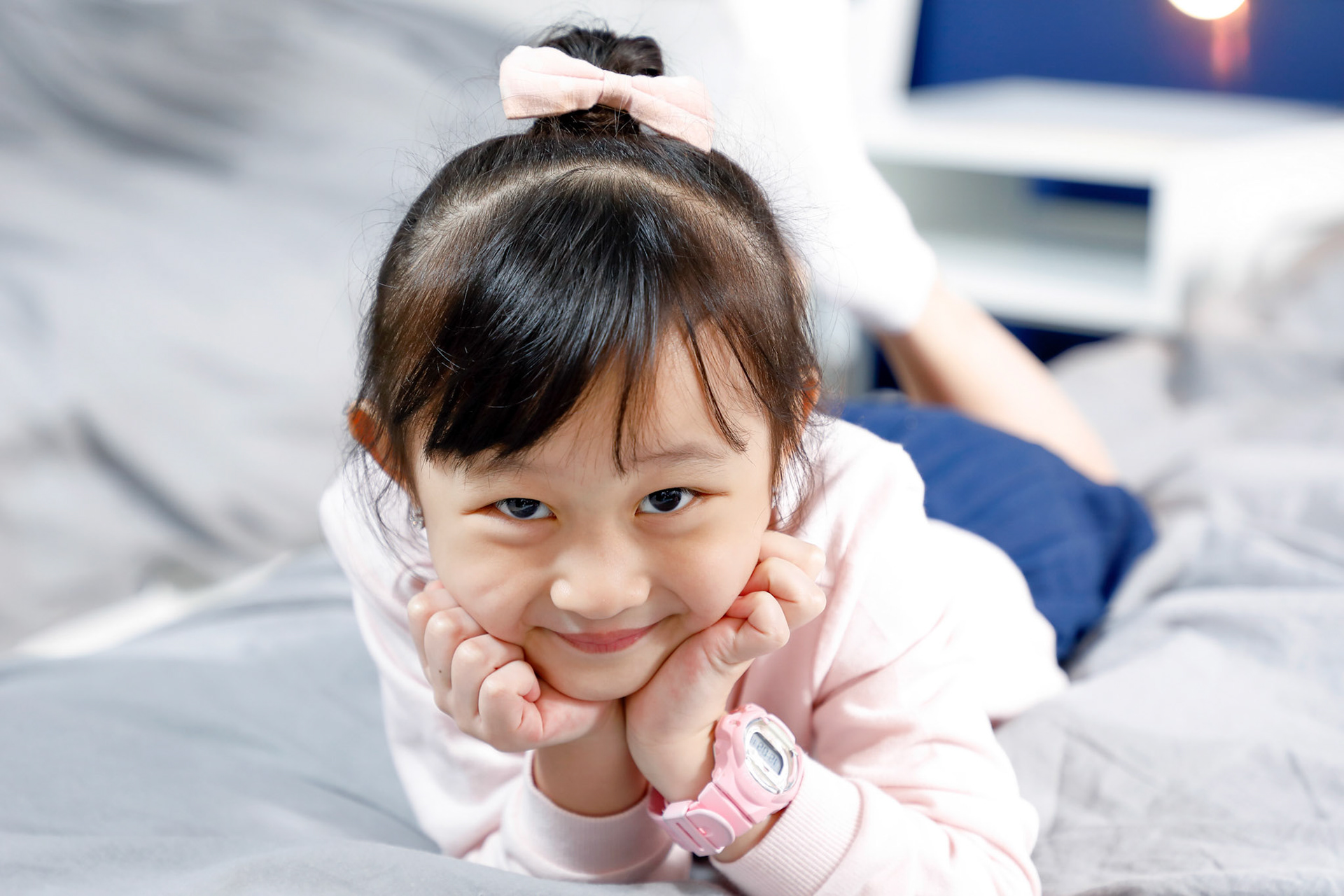 One girl children lying on bed looking forward posing