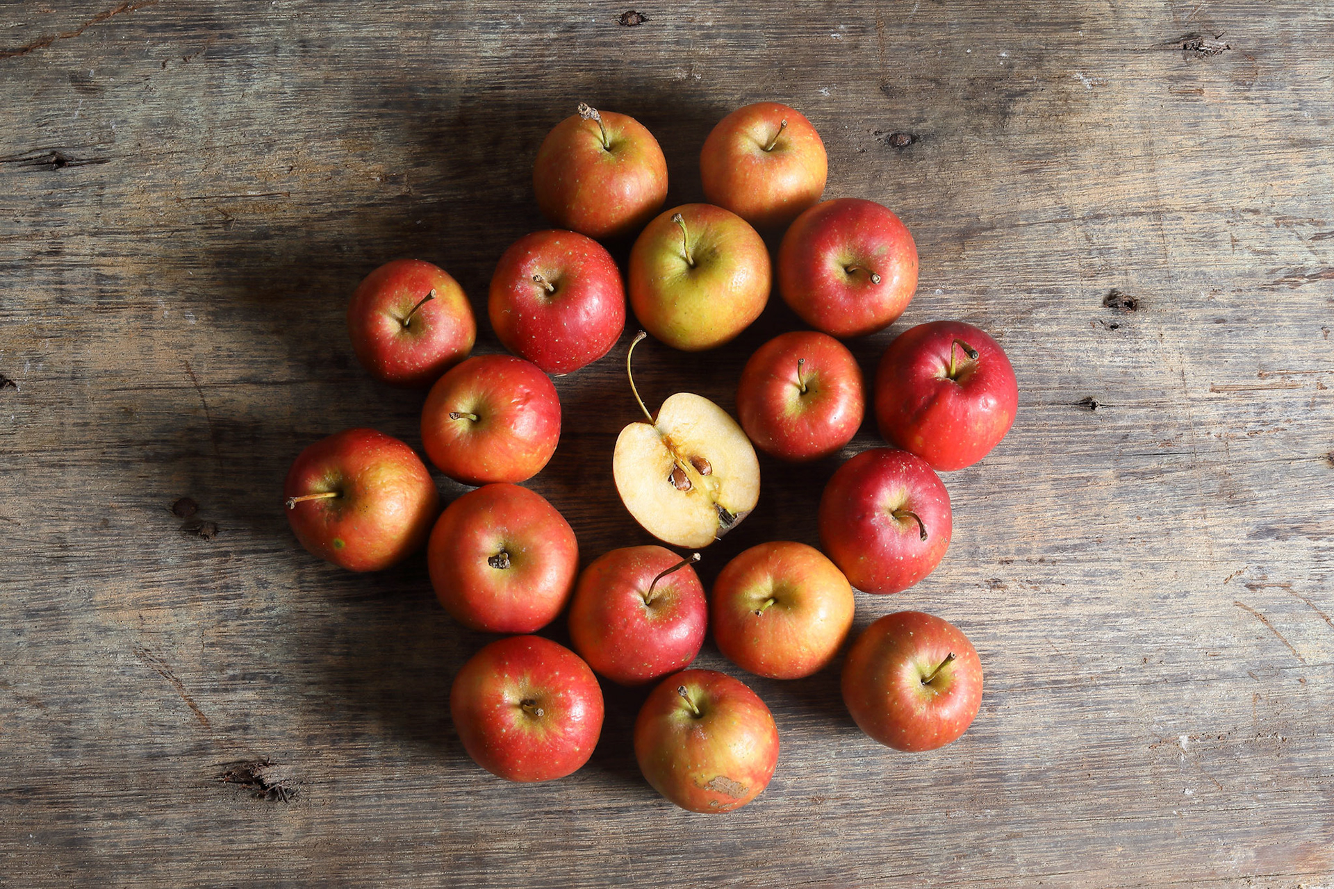 Small little Cherry Apple fruit red juicy fresh on rustic wood table