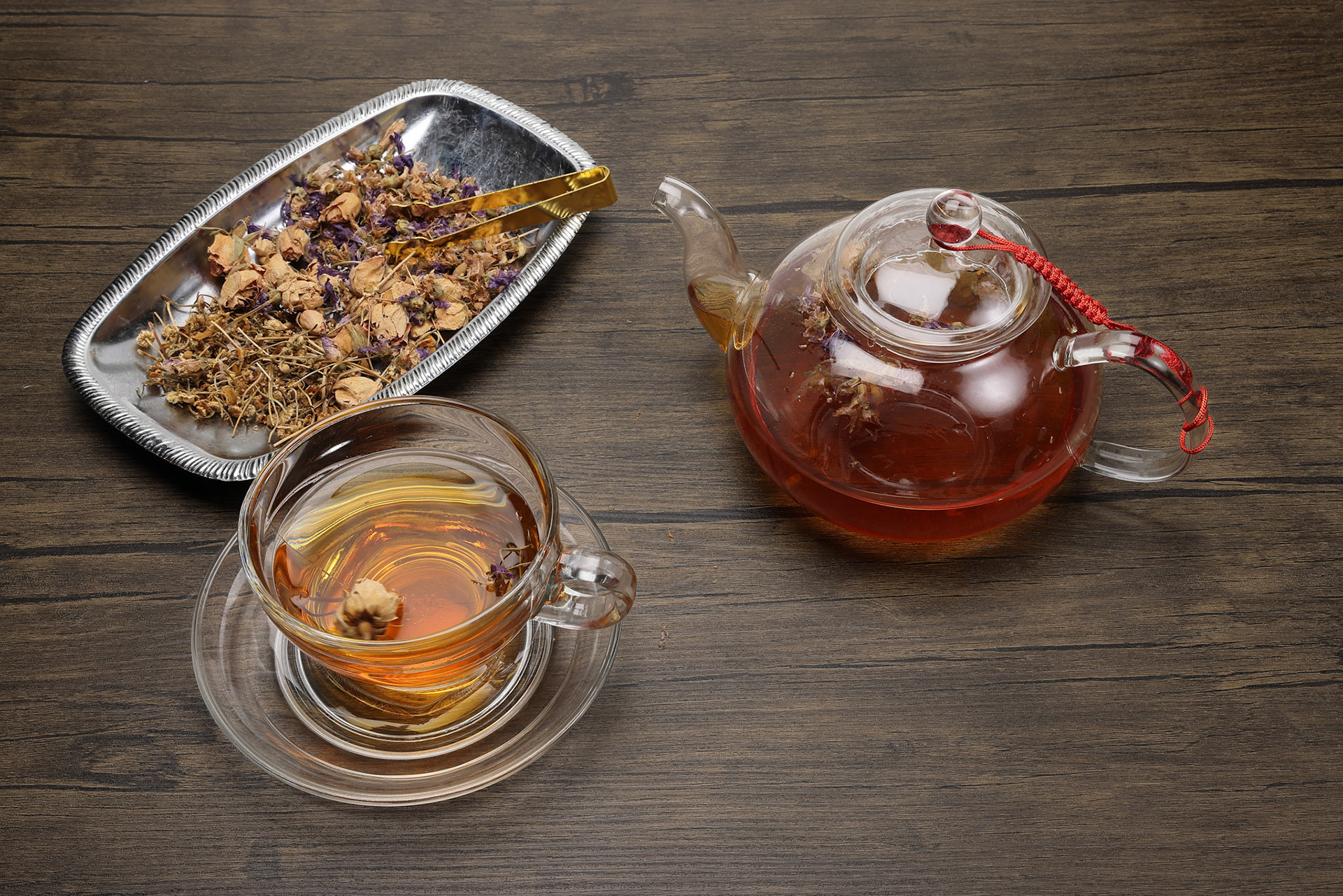 Make mix pour herbal floral tea drink transparent glass teapot to teacup twister pick up put rustic wooden table