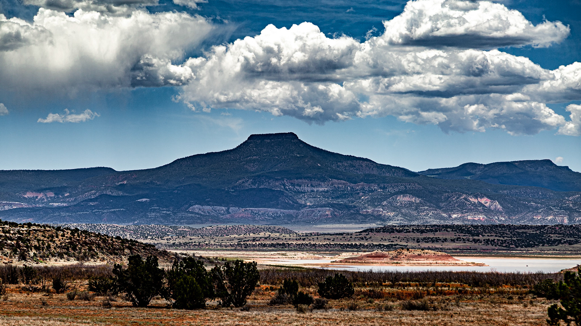 One of O’Keefe’s favorite subjects was Cerro Pedernal, the chopped-top mountain she saw from her kitchen window at Ghost Ranch.  “It is my private mountain,” she once said.  “It belongs to me.  God told me if I painted it enough, I could have it.”  In a way, this declaration was made true when O’Keefe’s ashes were scattered on Pedernal upon her death in 1986.  ---  In 2013 and on this 2021 trip, I felt frustrated that my images of it seemed too much like silhouettes.  Recent reflection reminds me that Georgia’s paintings I remember of it lso have a silhouette quality.  Maybe I was working to make mine too perfect to realize beauty.