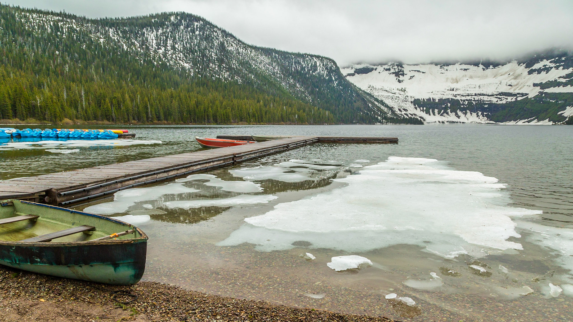 Despite the ice on the lake and no one renting the boats, there were a couple of men washing one of them on the shore just out of this scene. A few people came and left while we were there. It was pretty cool and drizzly. Nevertheless, it was an attractive scene.  I suspect the busy tourist season is a little later than we were there.