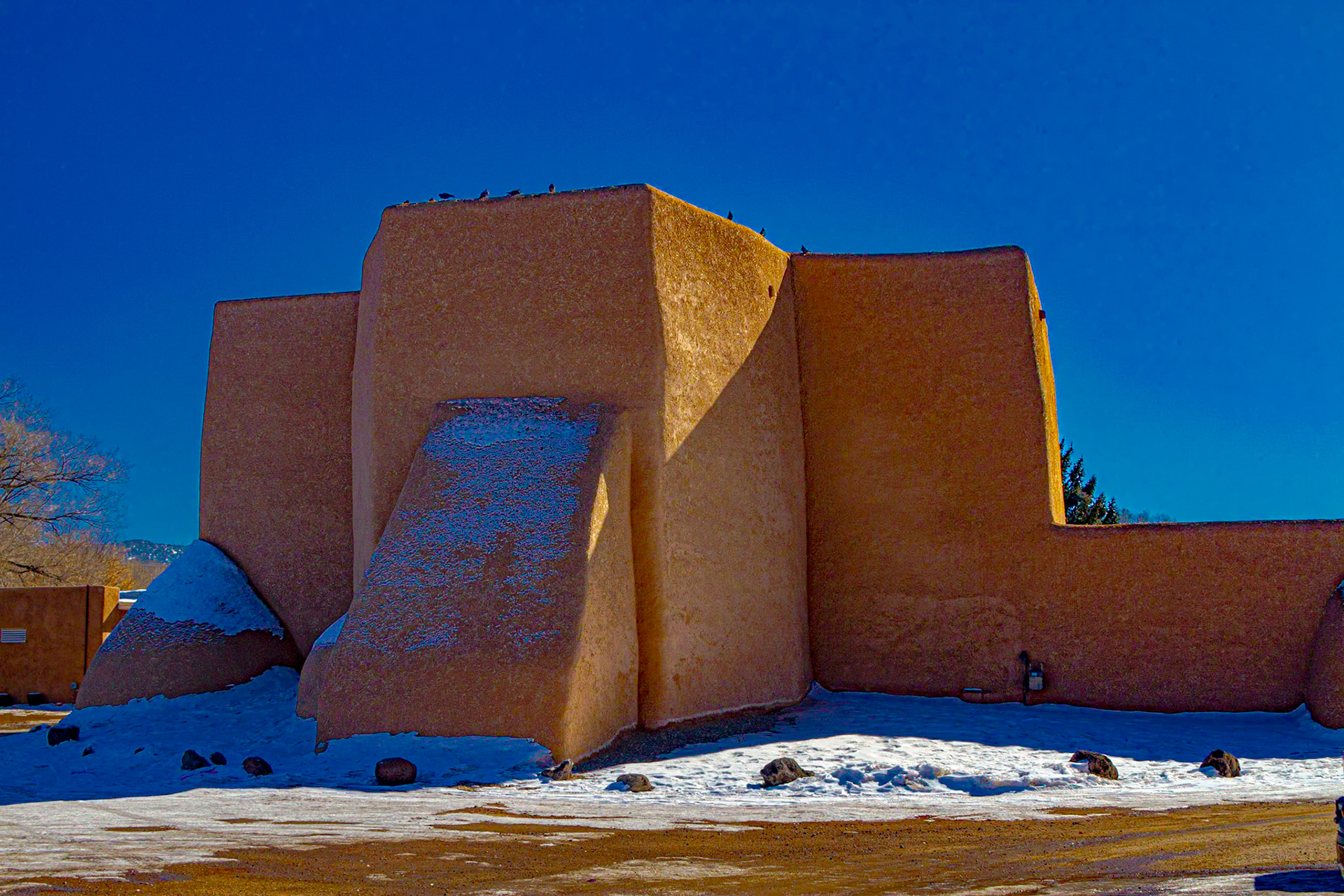 For our second day, we went north to Taos.  Driving through Ranchos de Taos, I saw the back of San Francisco de Asis, which is in one of my Ansel Adams books.  It is also on the cover of a book I saw at Abiquiu the day before.  That book cover had Adam’s image alongside a painting from essentially the same vantage point by Georgia O’Keeffe.  The book seemed to be about the time they worked together and influenced each other.  After a few of my own images for the back of the church, we went around to the plaza, where I shot other images of the church and a few buildings around the plaza.  Interestingly, the caption in “Ansel Adams Photographs of the Southwest” is “St. Francis Church, Ranchos De Taos, New Mexico, c. 1958.”  The signs around the church indicate it is “San Francisco de Asis.”  I chose to rely on the signs.