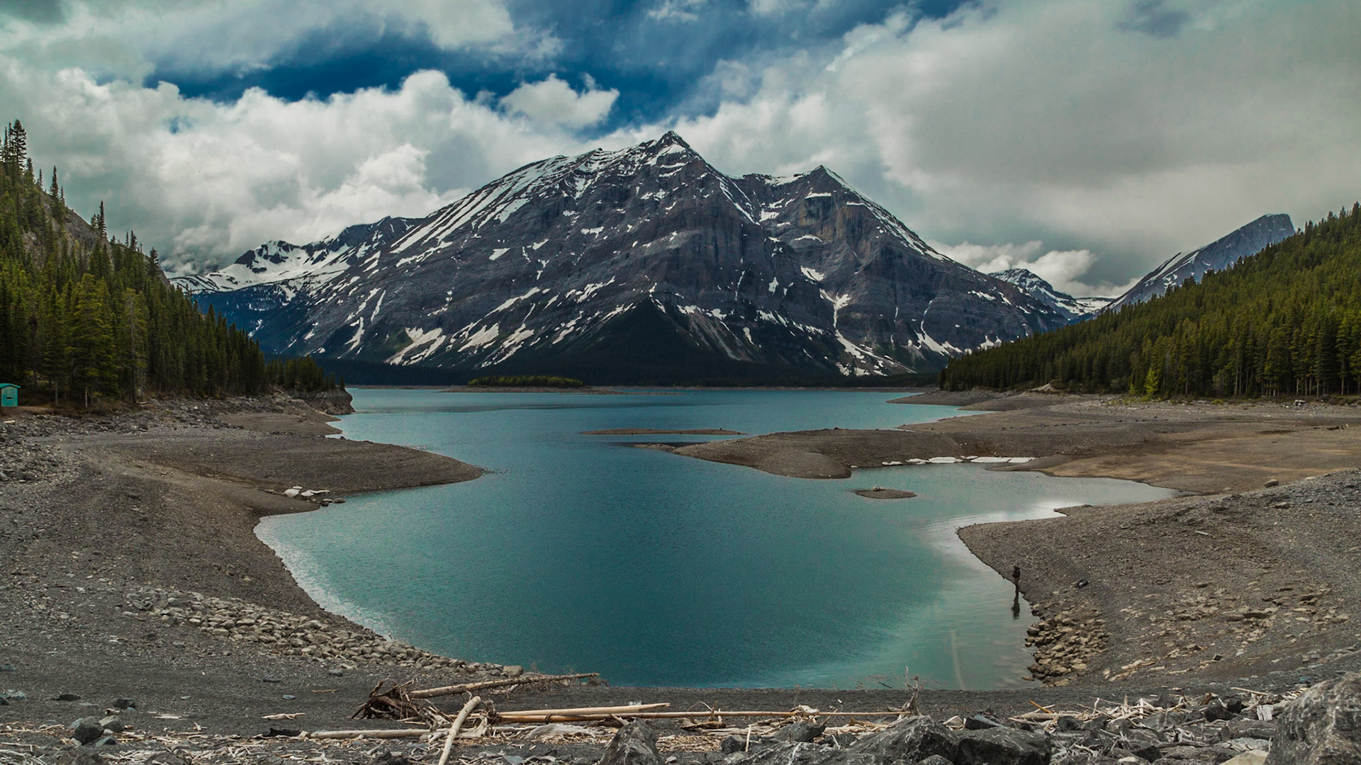 Exploring west of Highway 40 for a good while, making more or less random turns on dirt roads, we came to a manmade damn and lake. This water level was low, although several lakes we passed were more or less full. This one got enough of our attention to roam around the area for a good long while.  Maybe the guy fishing on the shore was the key for this stop. Maybe it was a feeling that the road didn’t go much higher into the mountains.  Who know? It was just a good stop.
