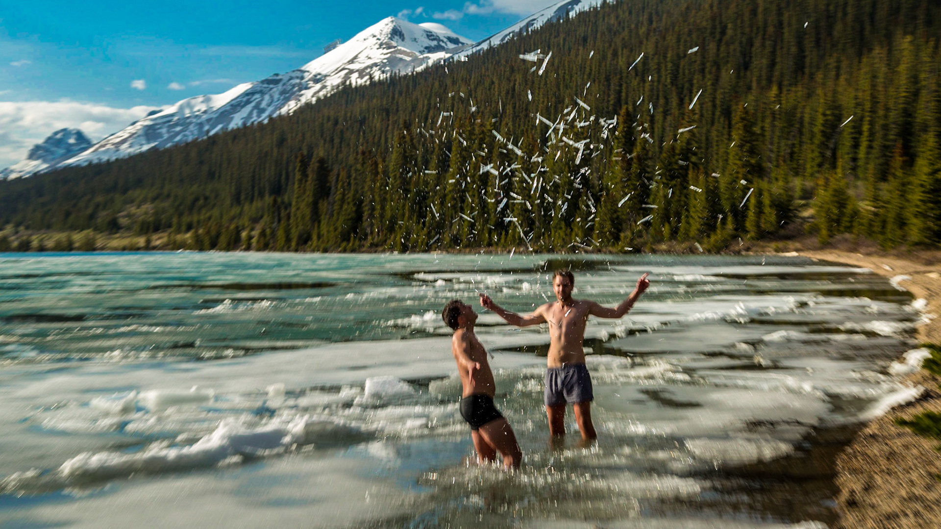 Back in the car, after a few shots at the Bow Lake overlook, Mark said “the Norwegian Polar is in the water down there” - pointing toward a beach area. We needed to see more.  It was five or six guys - probably in their 20’s.  The language they used most seemed to be something like German.  A couple of them could communicate with us in English.  And, they were stripped to their undershorts – boxers or otherwise.  Apparently, they had all been into the water.  Two were still playing with the ice.  Others were taking pictures and said it was alright for us to shoot.  There was a neatly folded and piled set of cloths - except the underwear.
