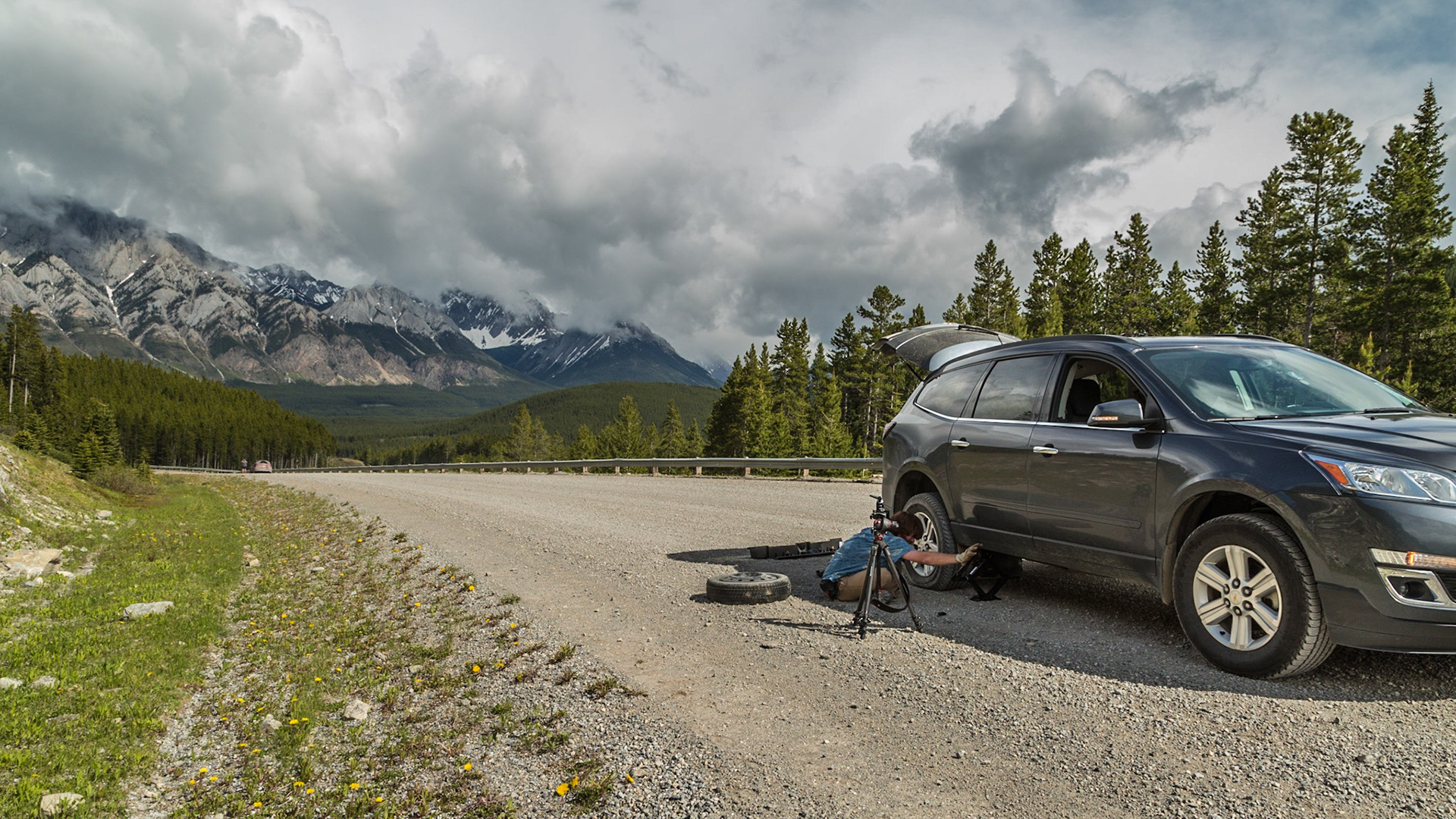 Every adventure needs a mishap. We were gone from home 8 days, carrying a lot of photographic equipment and other stuff. To my knowledge, this tire was the only thing we lost. When it happened, I was in denial until we got stopped and Mark said “No, it is flat.” The torn place was at least an inch long. Otherwise, I was in luck, with a thirty year old guy thrilled to set up a GoPro camera to record the entire operation. It’s not joke. He had the tripod set up in just the right place, before we started figuring out how to get the temporary tire and jack out of the curious storage places. His camera rigging took about the same amount of thought as getting ready to jack the car. Then I was able to enjoy the wilderness beauty while he became the star of his movie.