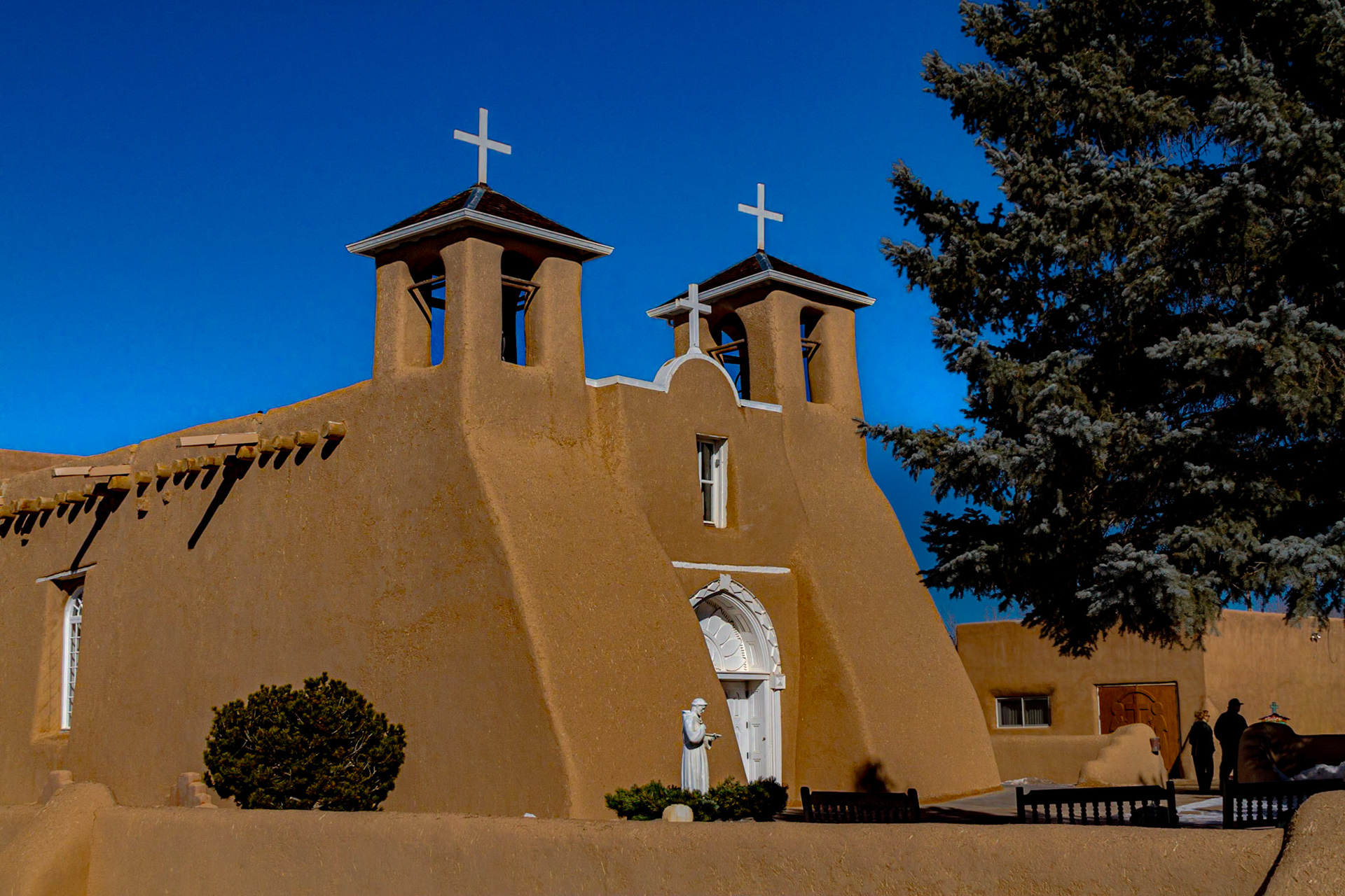 For our second day, we went north to Taos.  Driving through Ranchos de Taos, I saw the back of San Francisco de Asis, which is in one of my Ansel Adams books.  It is also on the cover of a book I saw at Abiquiu the day before.  That book cover had Adam’s image alongside a painting from essentially the same vantage point by Georgia O’Keeffe.  The book seemed to be about the time they worked together and influenced each other.  After a few of my own images for the back of the church, we went around to the plaza, where I shot other images of the church and a few buildings around the plaza.  Interestingly, the caption in “Ansel Adams Photographs of the Southwest” is “St. Francis Church, Ranchos De Taos, New Mexico, c. 1958.”  The signs around the church indicate it is “San Francisco de Asis.”  I chose to rely on the signs.