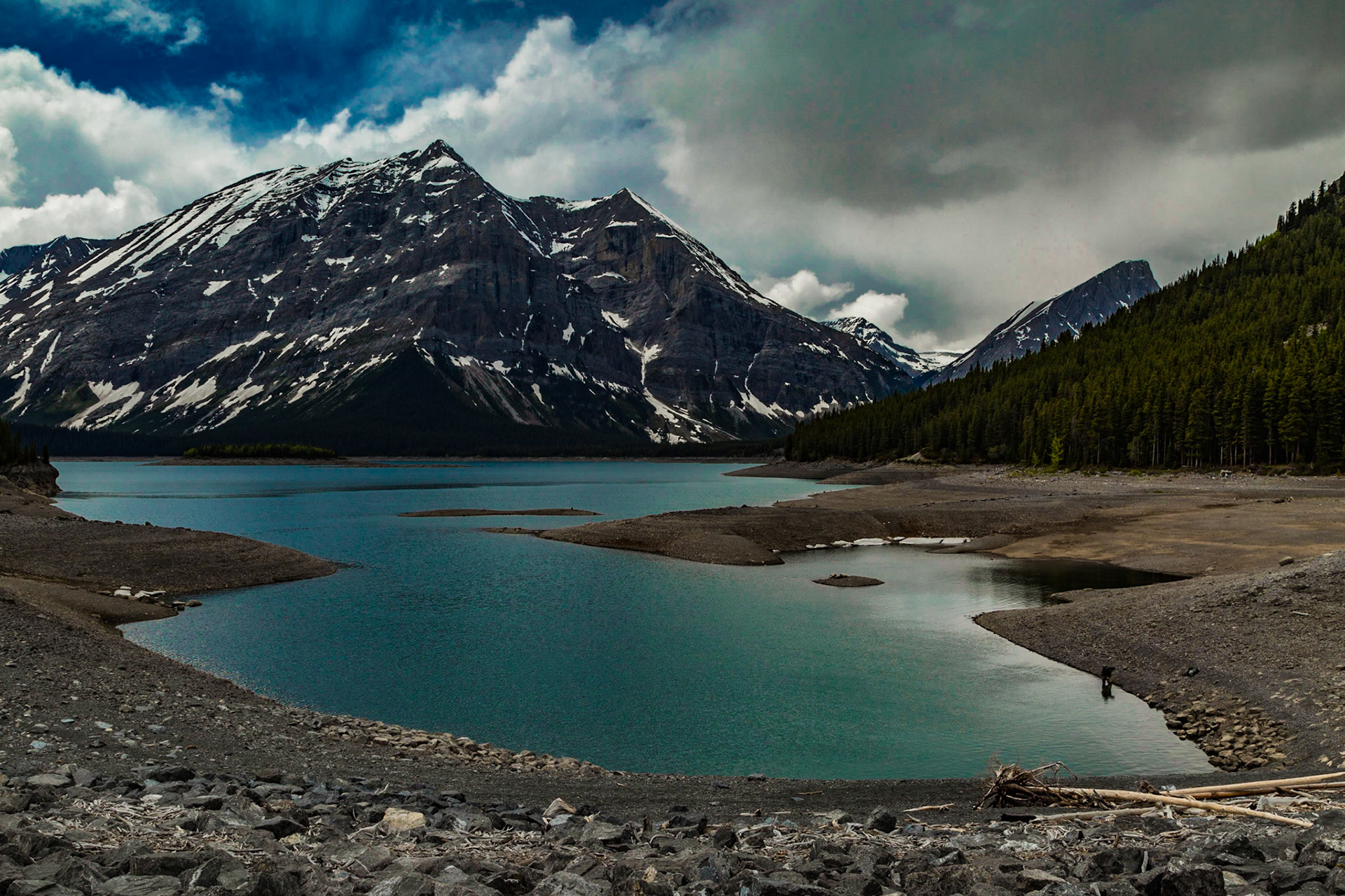 Exploring west of Highway 40 for a good while, making more or less random turns on dirt roads, we came to a manmade damn and lake. This water level was low, although several lakes we passed were more or less full. This one got enough of our attention to roam around the area for a good long while.  Maybe the guy fishing on the shore was the key for this stop. Maybe it was a feeling that the road didn’t go much higher into the mountains.  Who know? It was just a good stop.