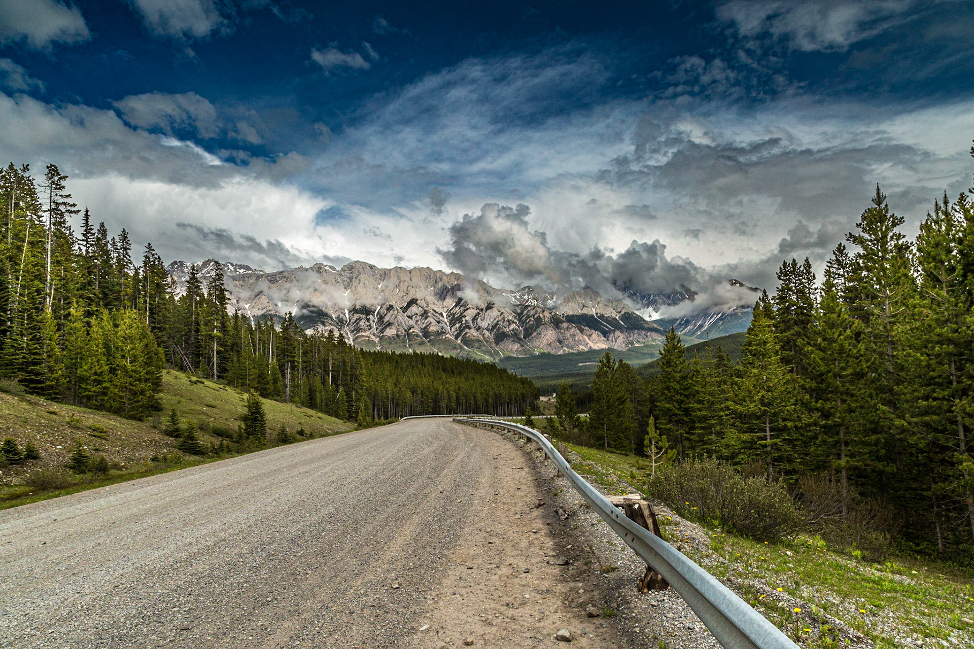 Every adventure needs a mishap. We were gone from home 8 days, carrying a lot of photographic equipment and other stuff. To my knowledge, this tire was the only thing we lost. When it happened, I was in denial until we got stopped and Mark said “No, it is flat.” The torn place was at least an inch long. Otherwise, I was in luck, with a thirty year old guy thrilled to set up a GoPro camera to record the entire operation. It’s not joke. He had the tripod set up in just the right place, before we started figuring out how to get the temporary tire and jack out of the curious storage places. His camera rigging took about the same amount of thought as getting ready to jack the car. Then I was able to enjoy the wilderness beauty while he became the star of his movie.