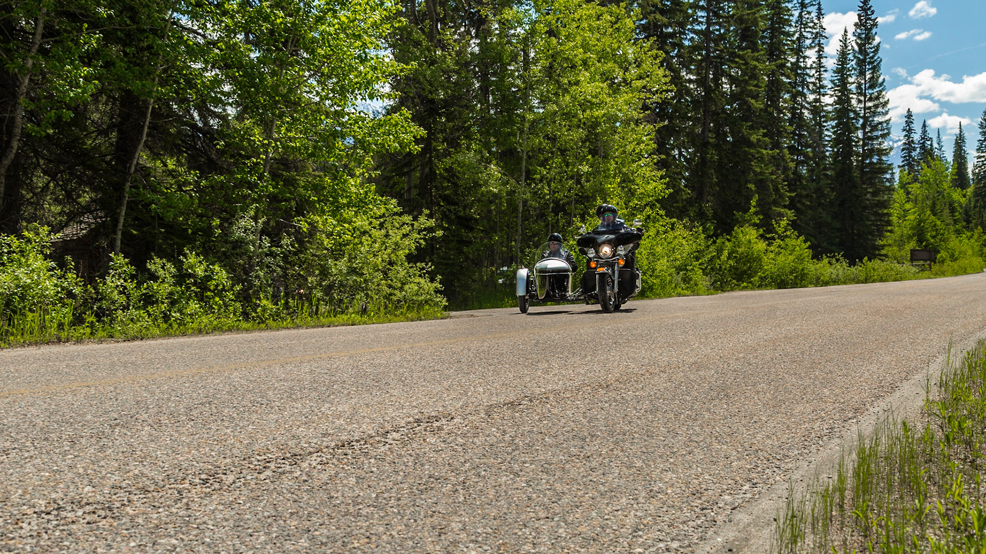 After a day that was mostly getting the flat tire replaced, a pub lunch and our hurried trip north on Icefield Parkway (June 17), we were ready to head south on the route that inspired Jasper, Alberta for this Father’s Day adventure. Highway 93 runs from Jasper to the Mexican border, through a vast array of landscapes. This year, we made it from Jasper to Kalispell. In 2015, we currently expect another lag of the trip. At the rate we travel, it may take three to four years to see all of Highway 93, if we actually make it. Until this point, the 2014 trip was an interesting way to reach our starting point.  The reasons have to do with airline schedules and my interest in seeing this route to Jasper.We began southbound on Icefield Parkway, with time for stops. Soon, we took a turn for a closer view of the Athabasca River, where we met five or six motorcycles with sidecars. Our reaction was wishing for a chance to shoot pictures. When this road turned away from the river we returned to a picnic area on the river. The motorcycles were there. It turns out they were not some kind of club, as we imagined. They were a Jasper tourist attraction. Guys in their 40s or 50s drove, carrying two tourists each – aging couples in this case. They were resting, before their return to Jasper on the road that might have been the “old highway” into Jasper.  We talked long enough to get a sense for their “mission.” That ride was probably expensive. When they were climbing into and onto the machines, we headed to setup for their departure. We got our chance for the shots we wanted earlier.